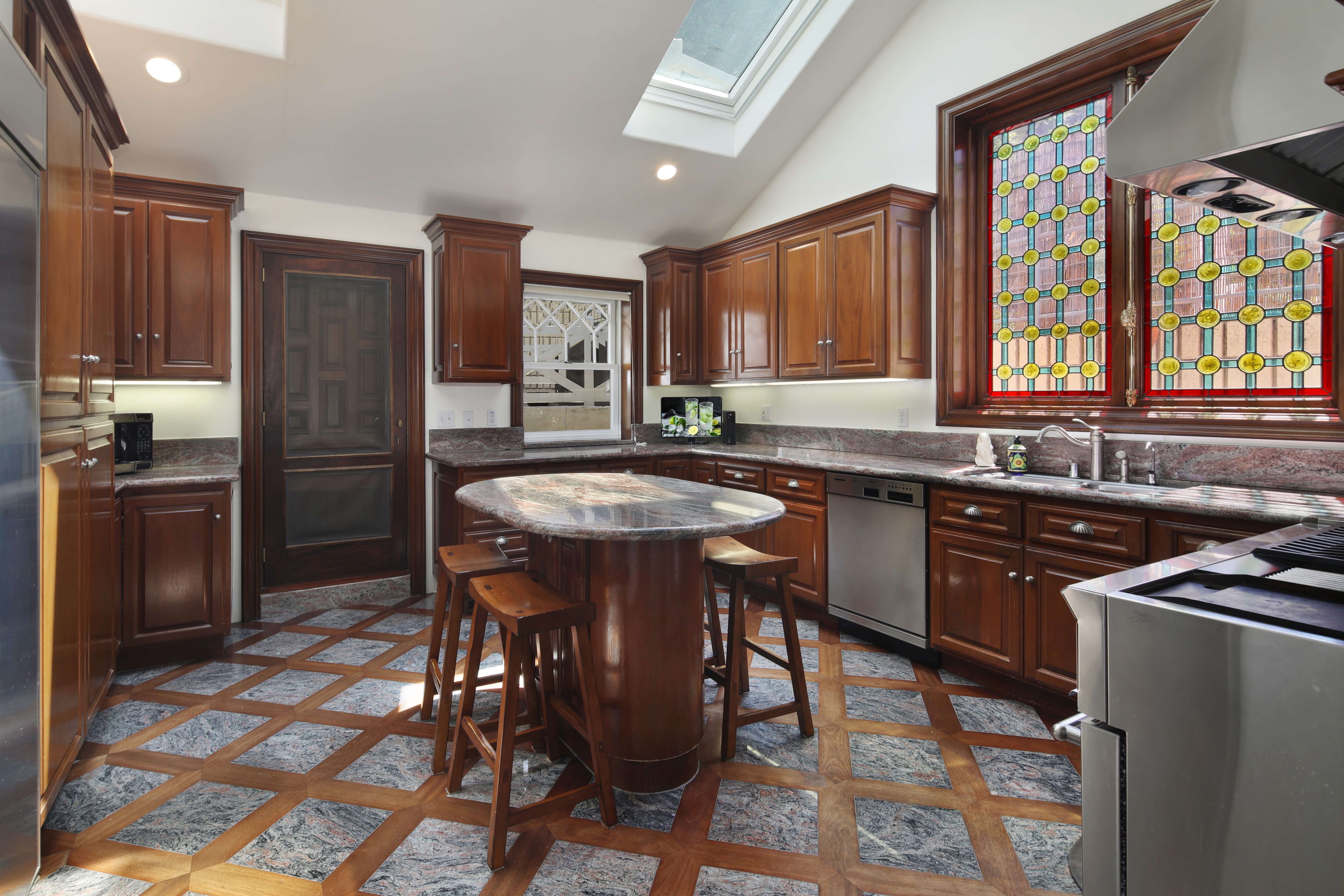 Kitchen with island and stained glass windows HD Wallpaper