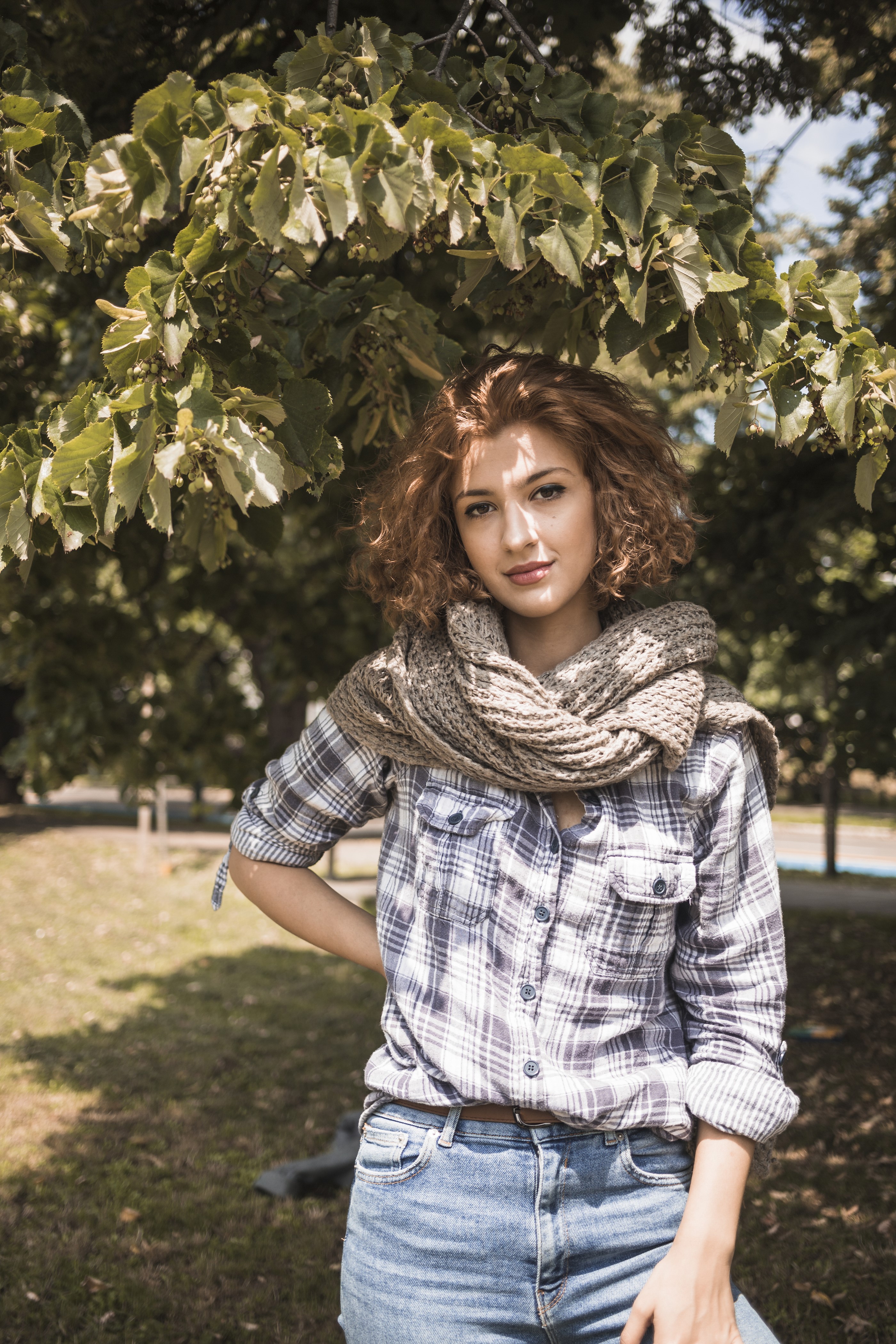 Woman with curly brown hair wearing a scarf and plaid shirt HD Phone Wallpaper