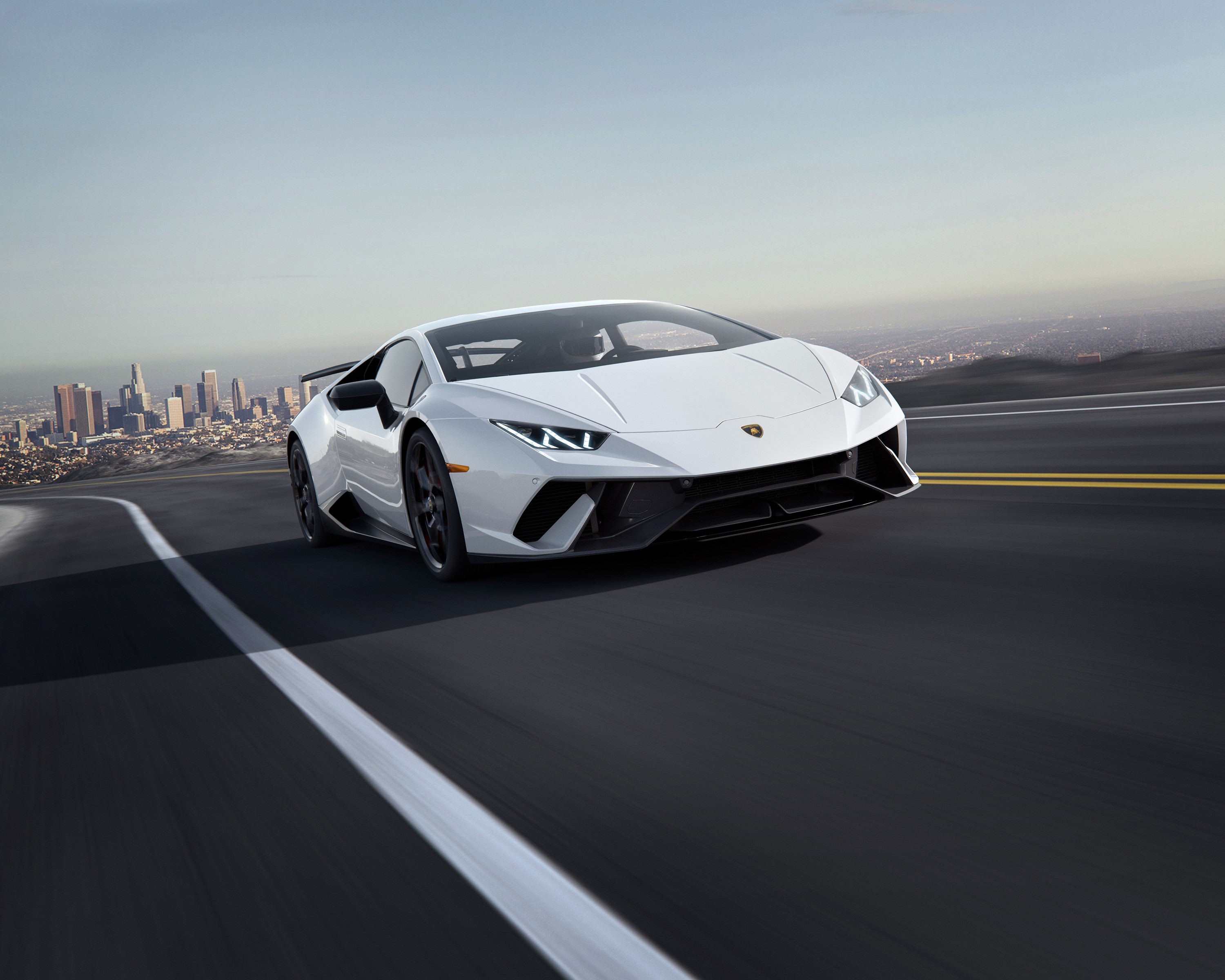White Lamborghini Huracan Performante driving on a road HD Wallpaper