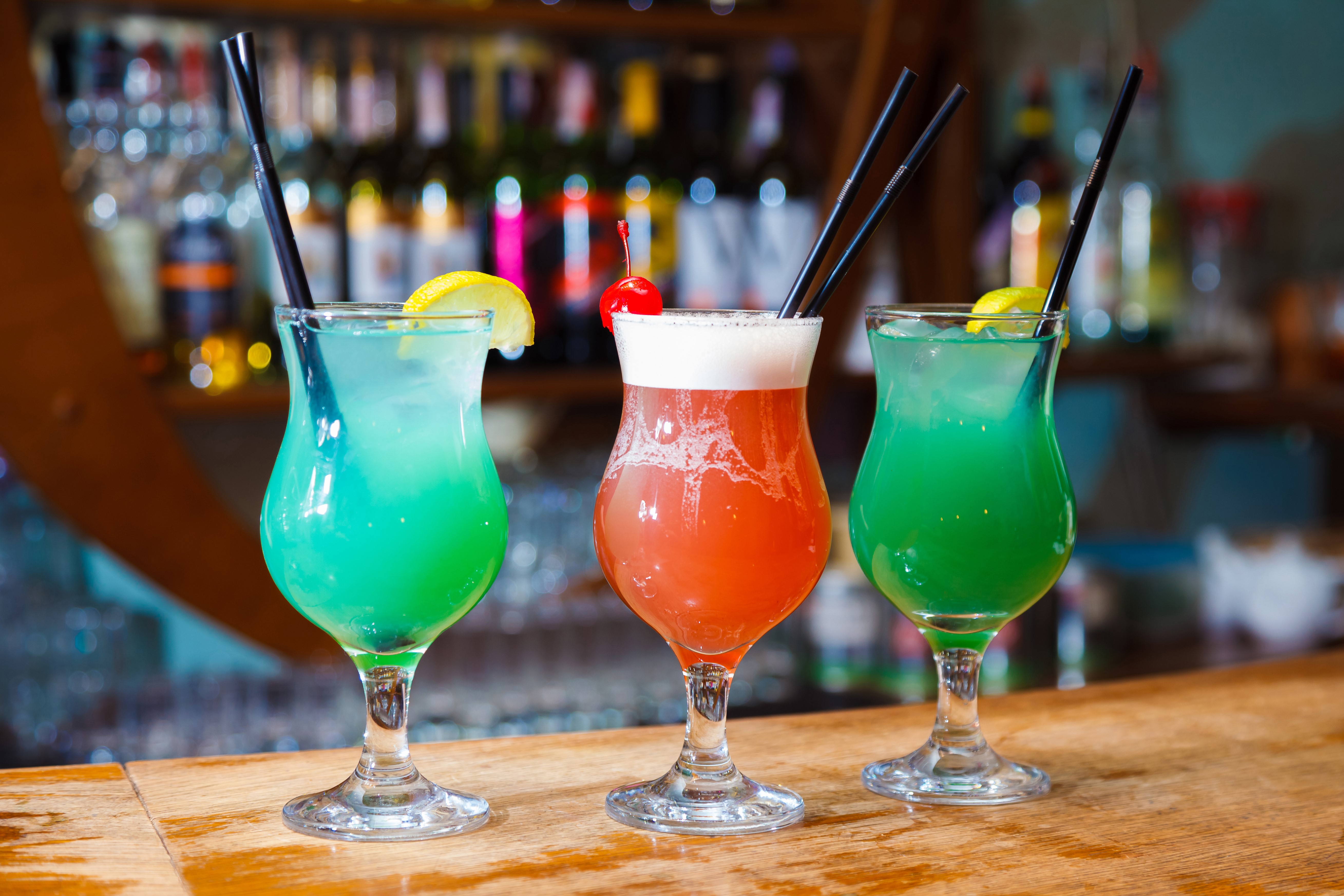 Three colorful cocktails on a bar HD Wallpaper