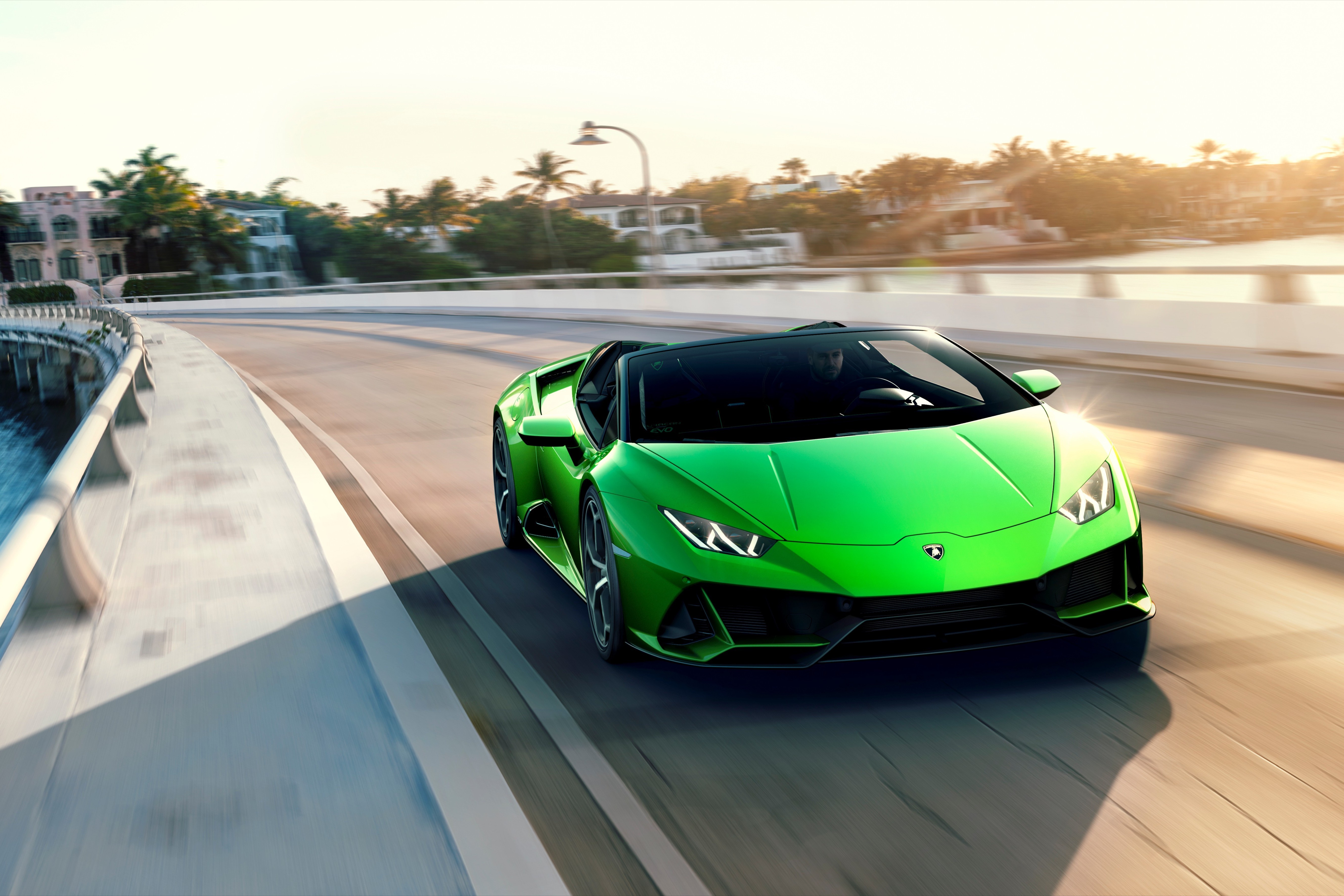 Green Lamborghini Spyder Evo Huracan driving on a road HD Wallpaper