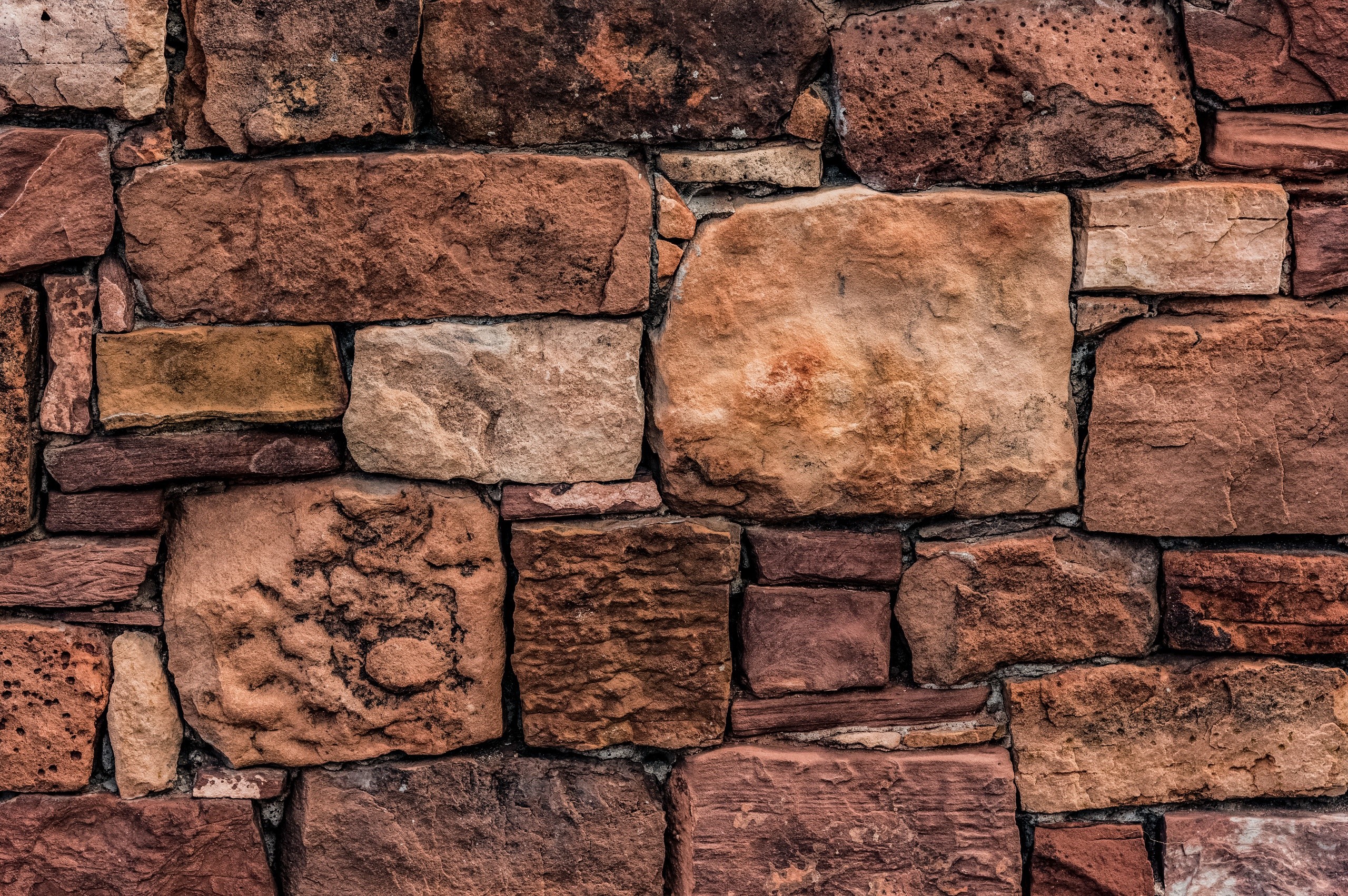 Close-up of a rustic stone wall texture HD Wallpaper