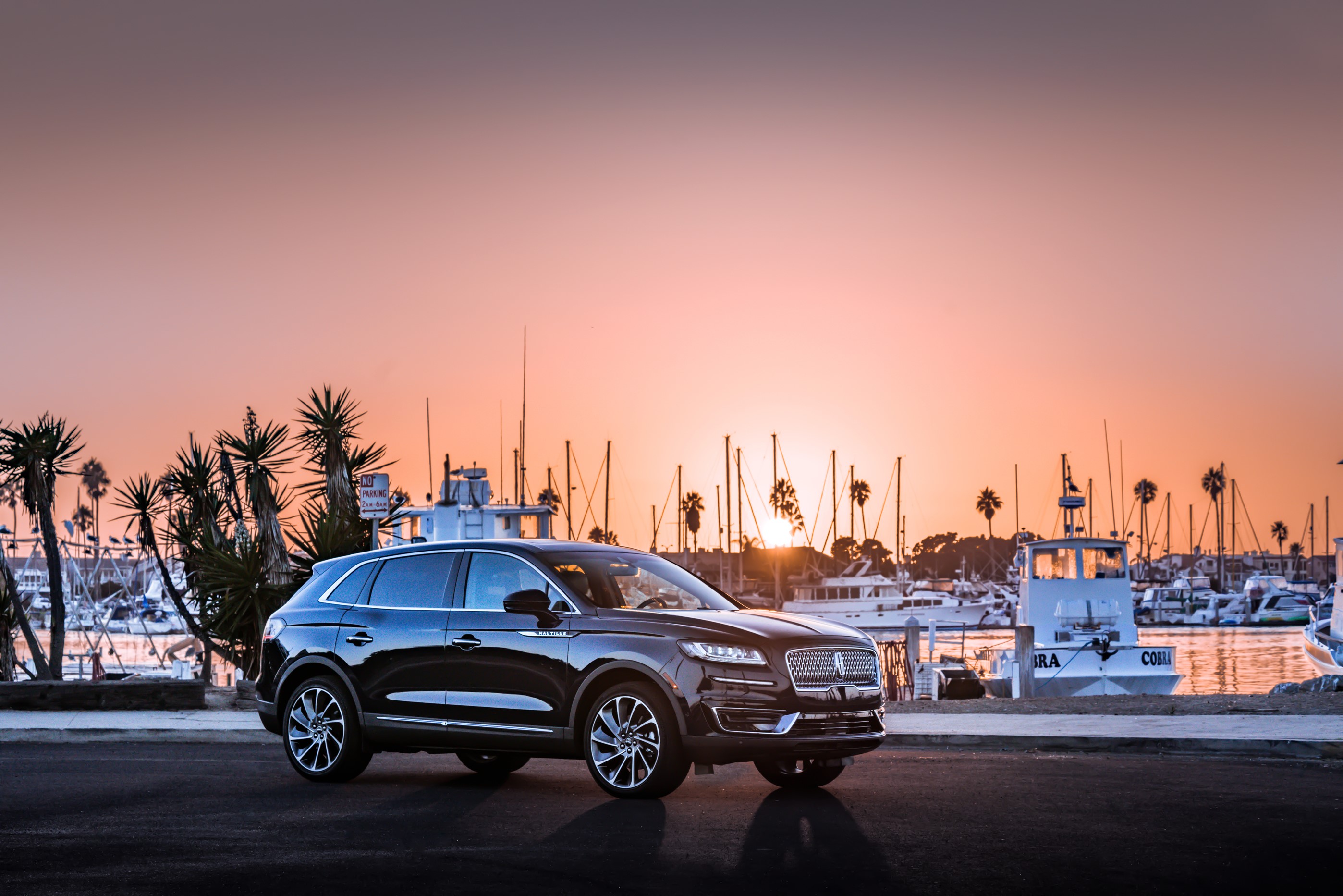 Black 2019 Lincoln Nautilus parked by a harbor at sunset HD Wallpaper
