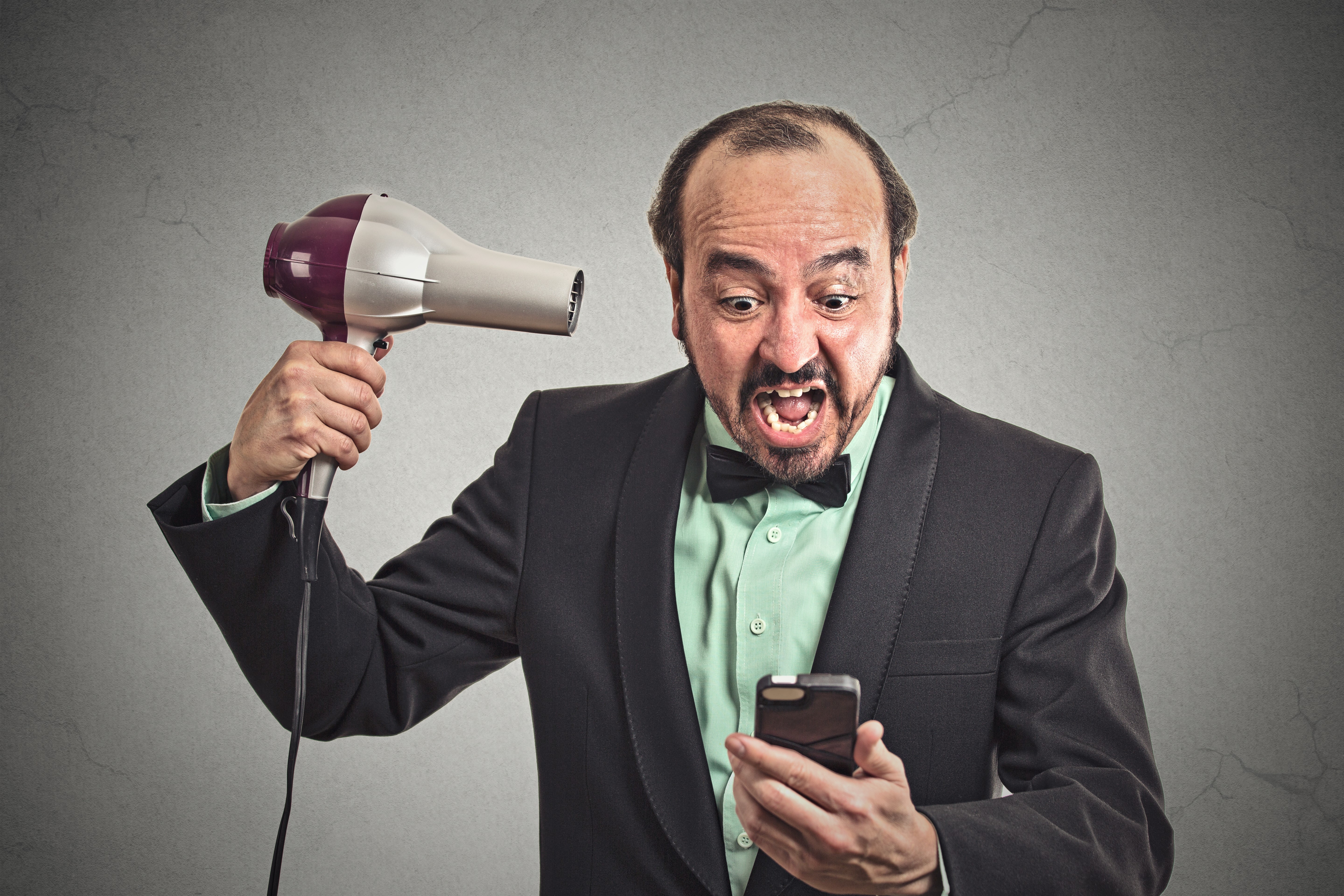 Man with hair dryer screaming at phone HD Wallpaper