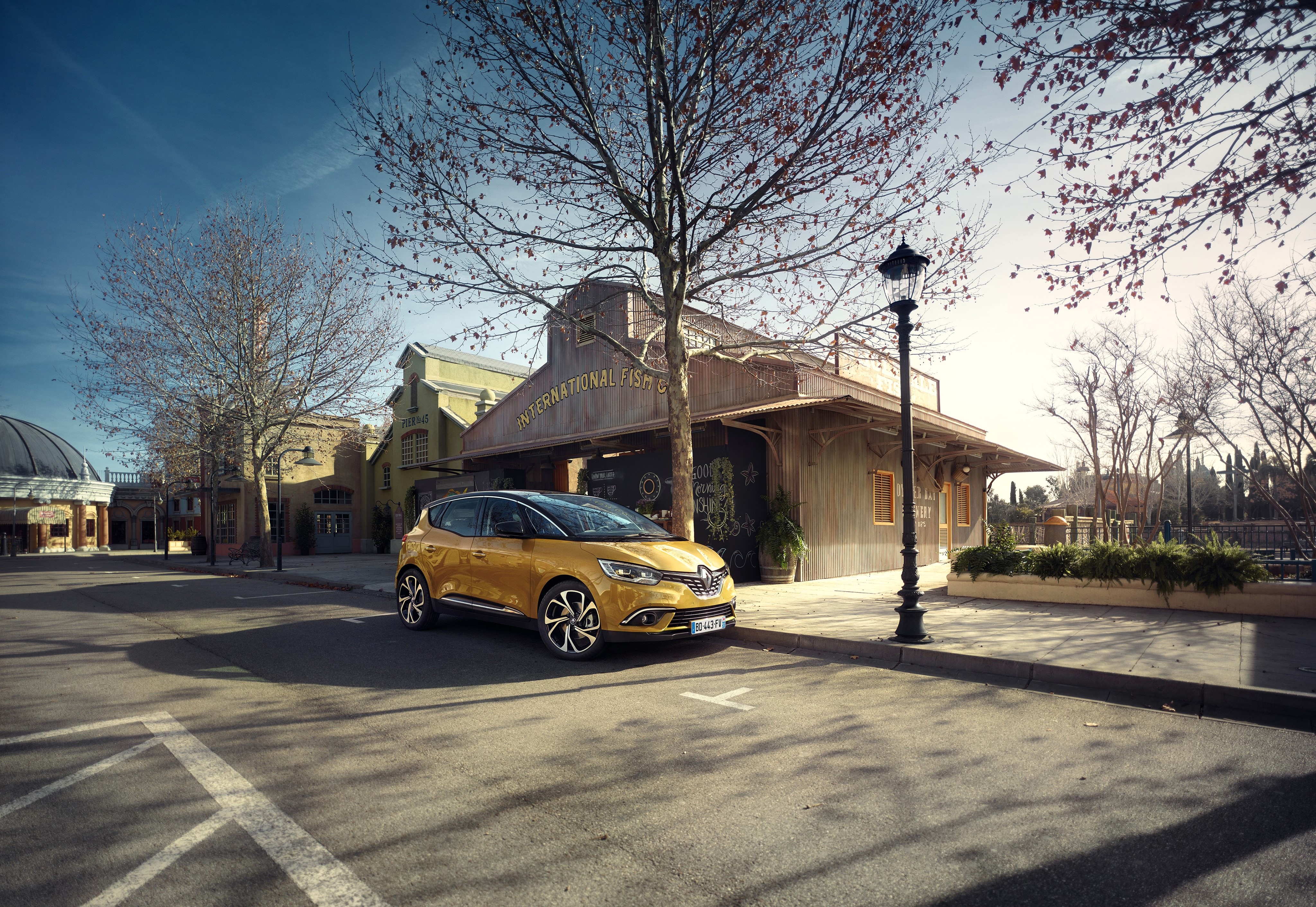 Yellow Renault Scenic parked near International Fish Co. HD Wallpaper