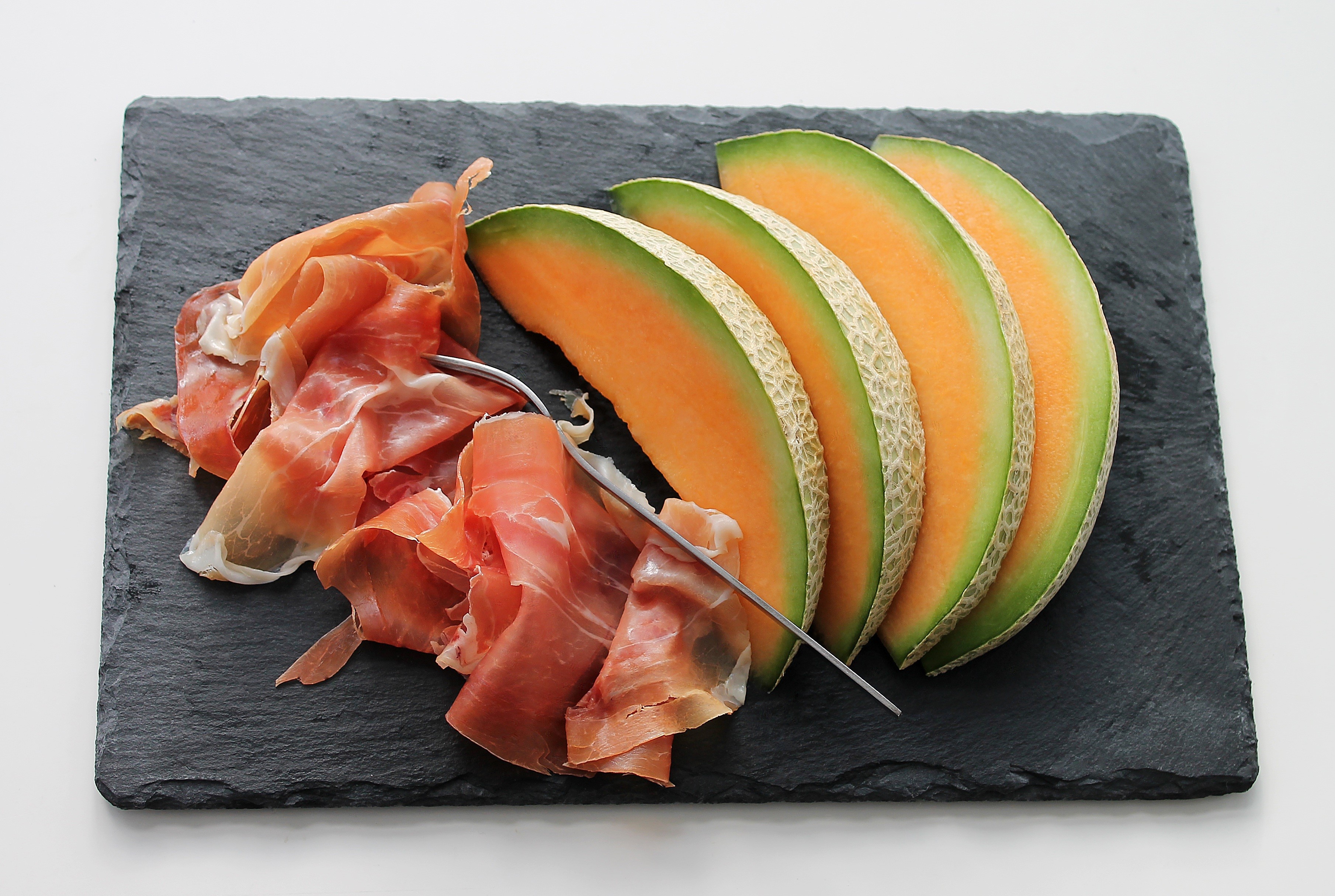 Prosciutto and Cantaloupe Slices on a Slate Board HD Wallpaper