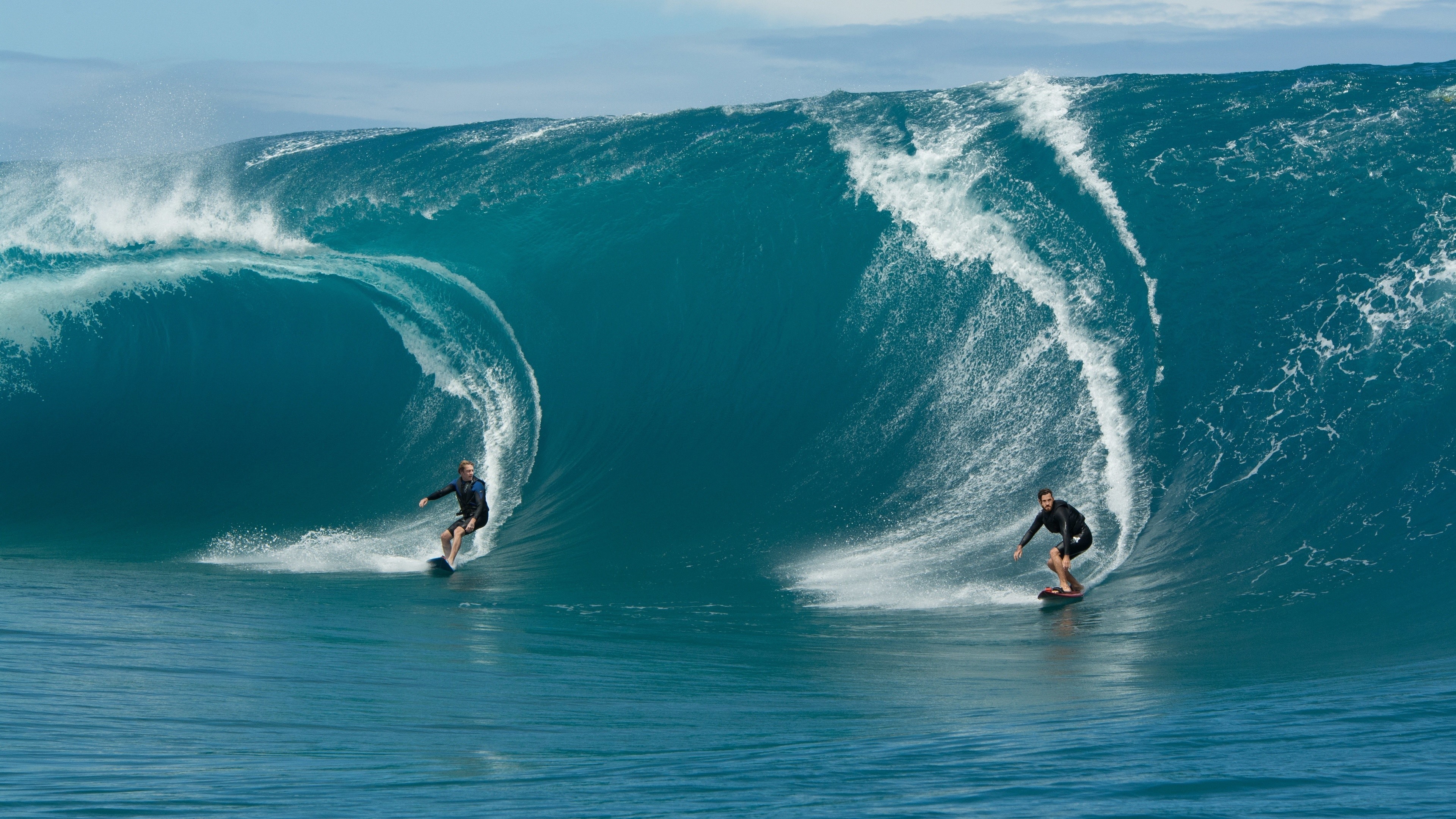 Two men surfing massive ocean waves HD Wallpaper