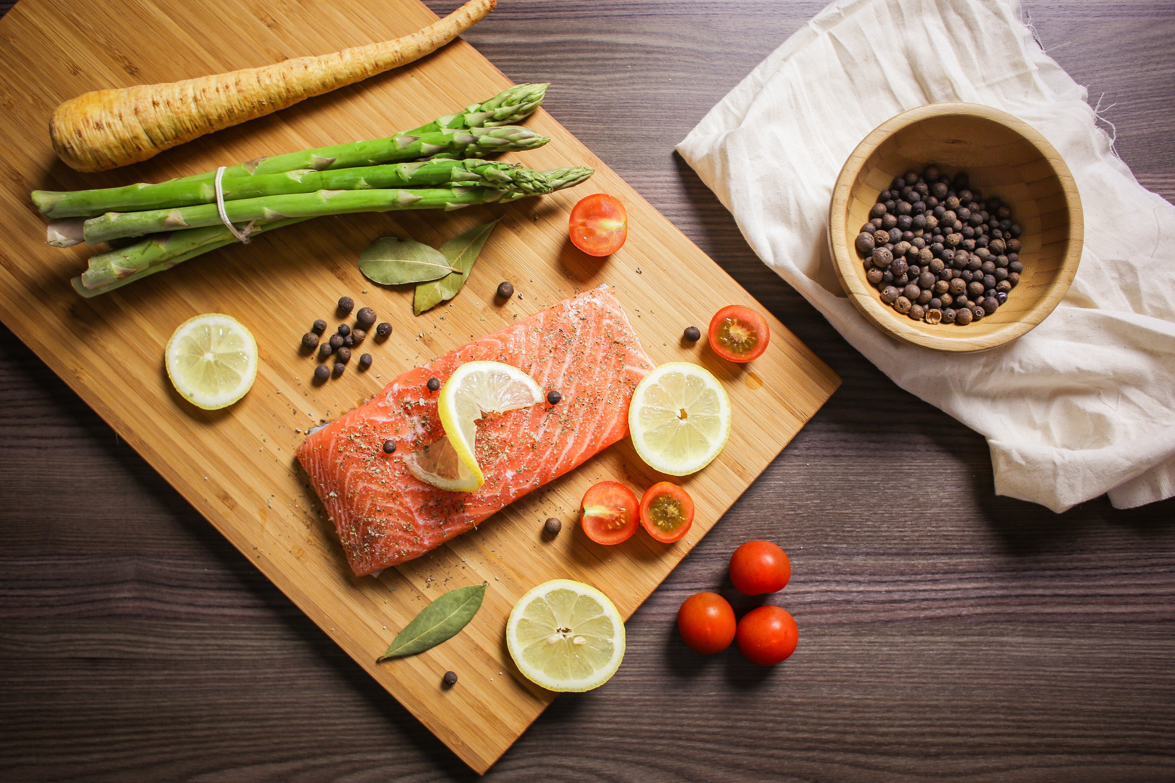 Salmon with Asparagus, Lemon, and Tomatoes on Cutting Board HD Wallpaper