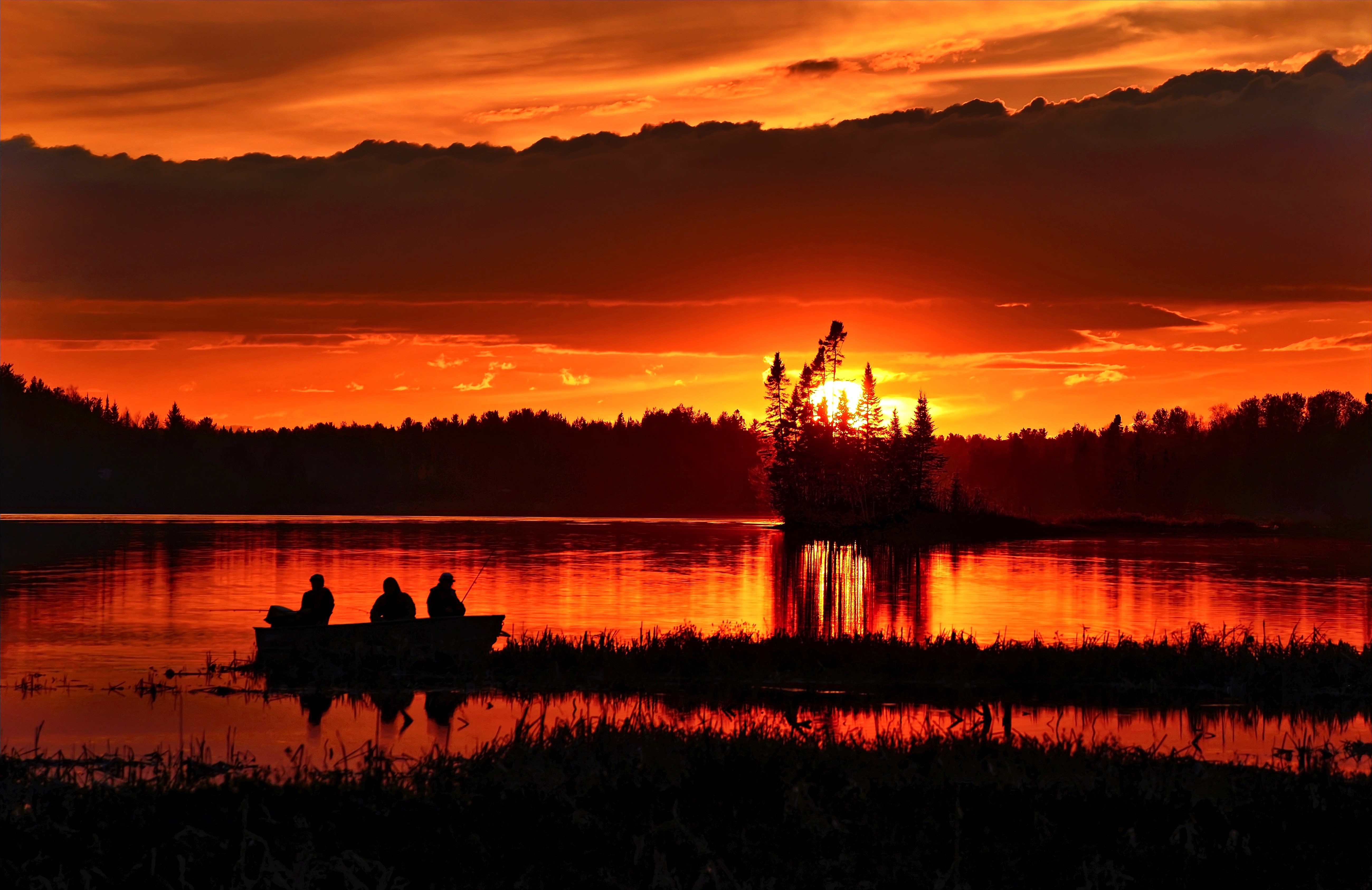 Fishing boat at sunset on a lake HD Wallpaper