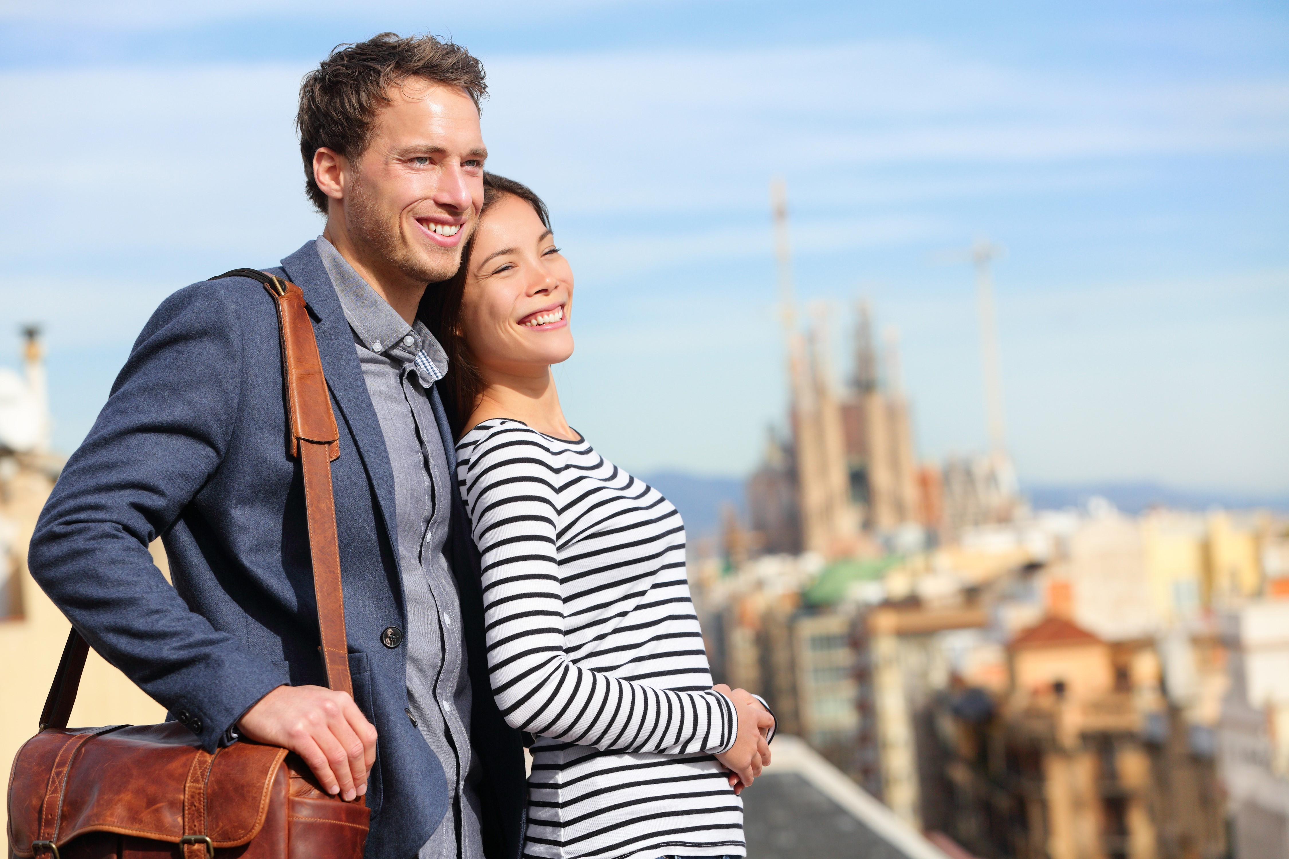 Couple smiling with Sagrada Familia in background HD Wallpaper