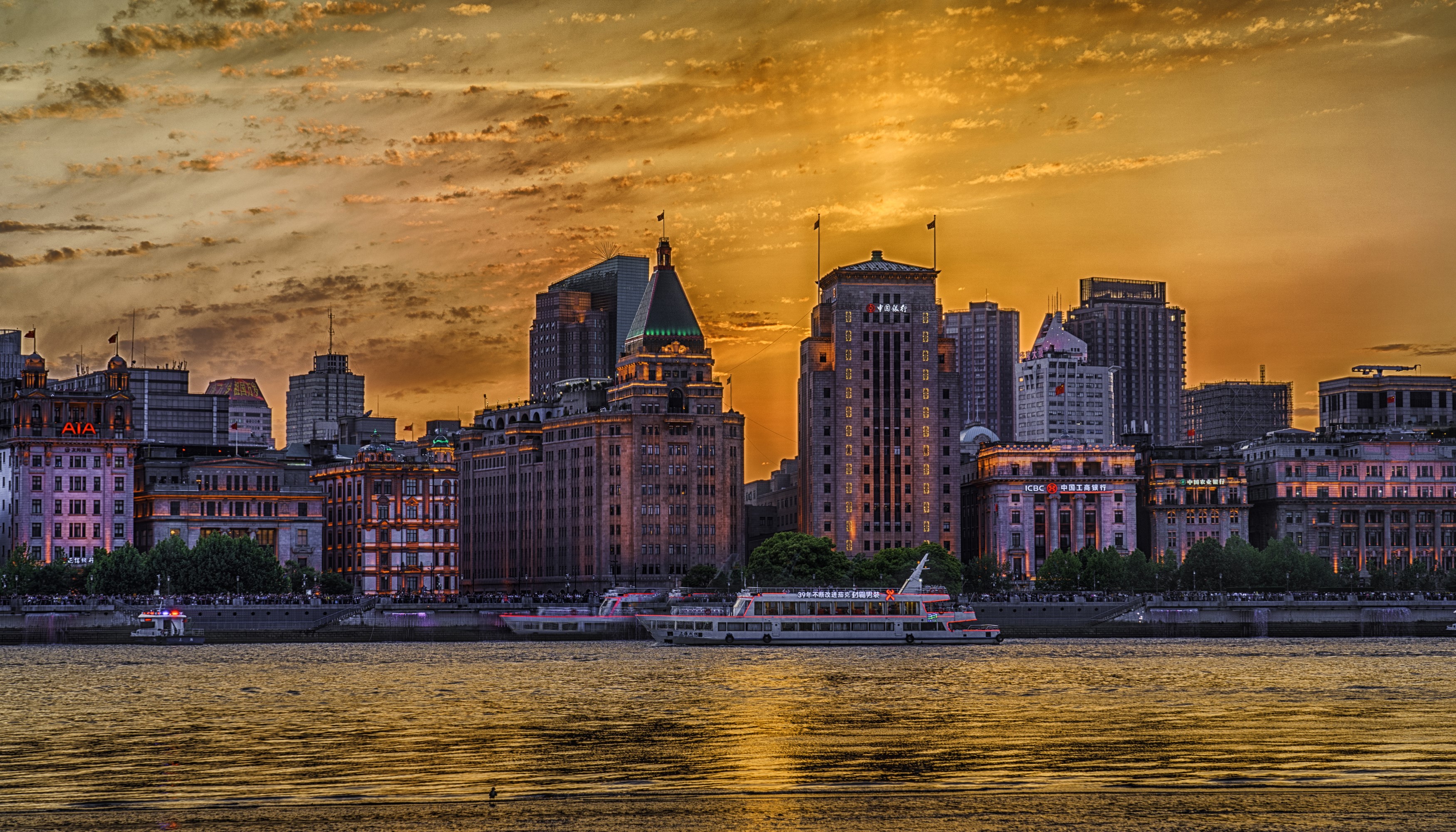 Shanghai skyline with river and boats at sunset HD Wallpaper