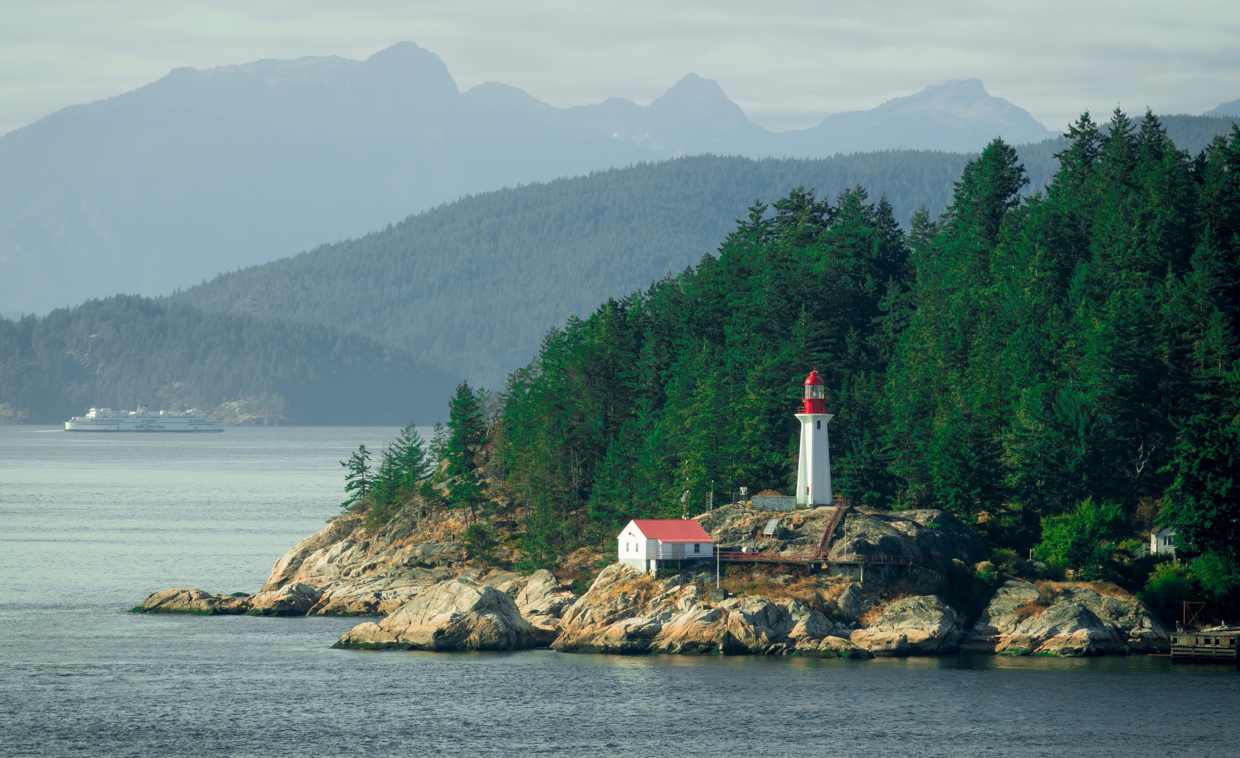 Lighthouse on rocky island in British Columbia, Canada HD Wallpaper