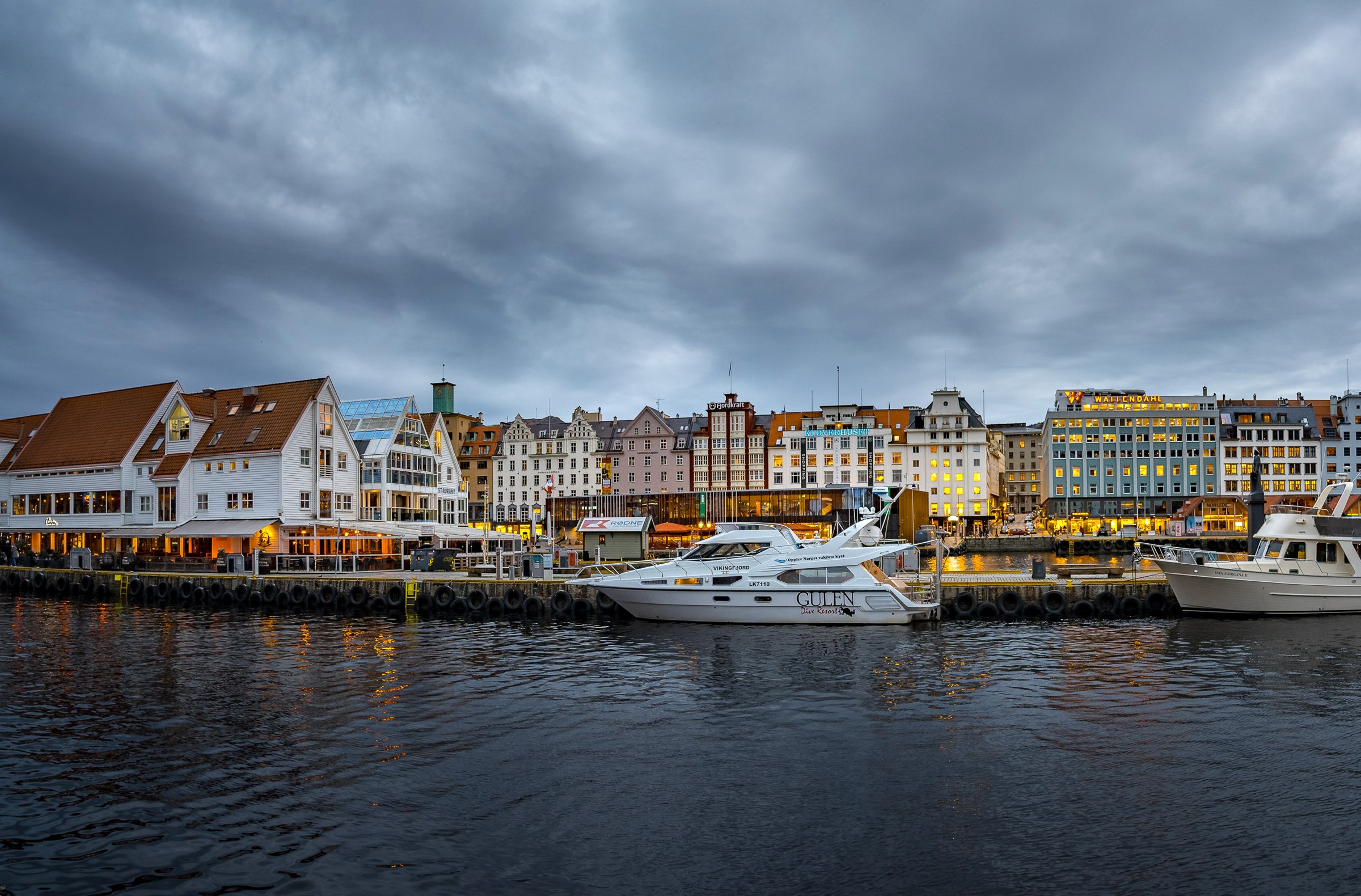 Yachts docked in a harbor with colorful buildings in Bergen, Norway HD Wallpaper
