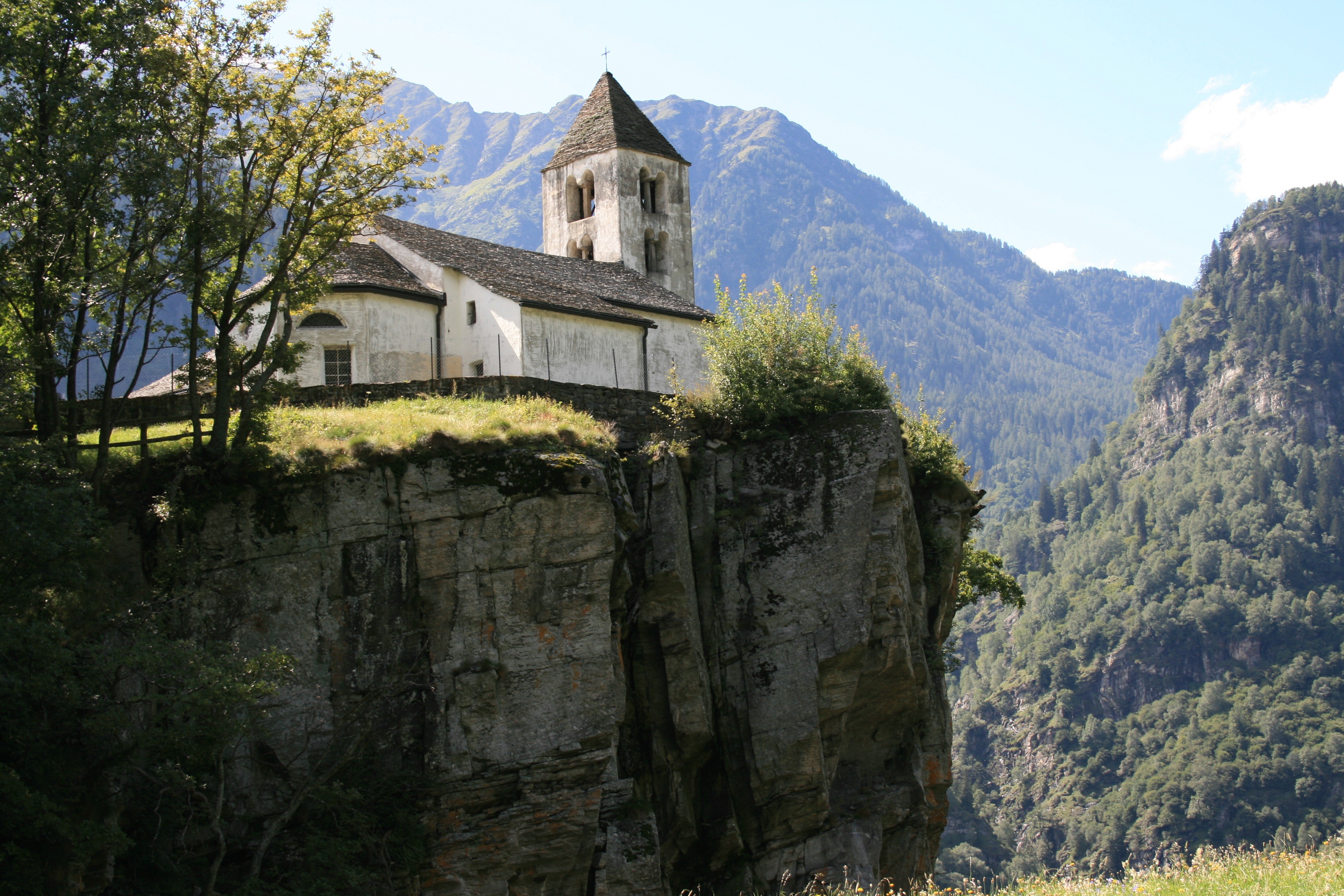 Church on a cliff in Ticino, Switzerland HD Wallpaper