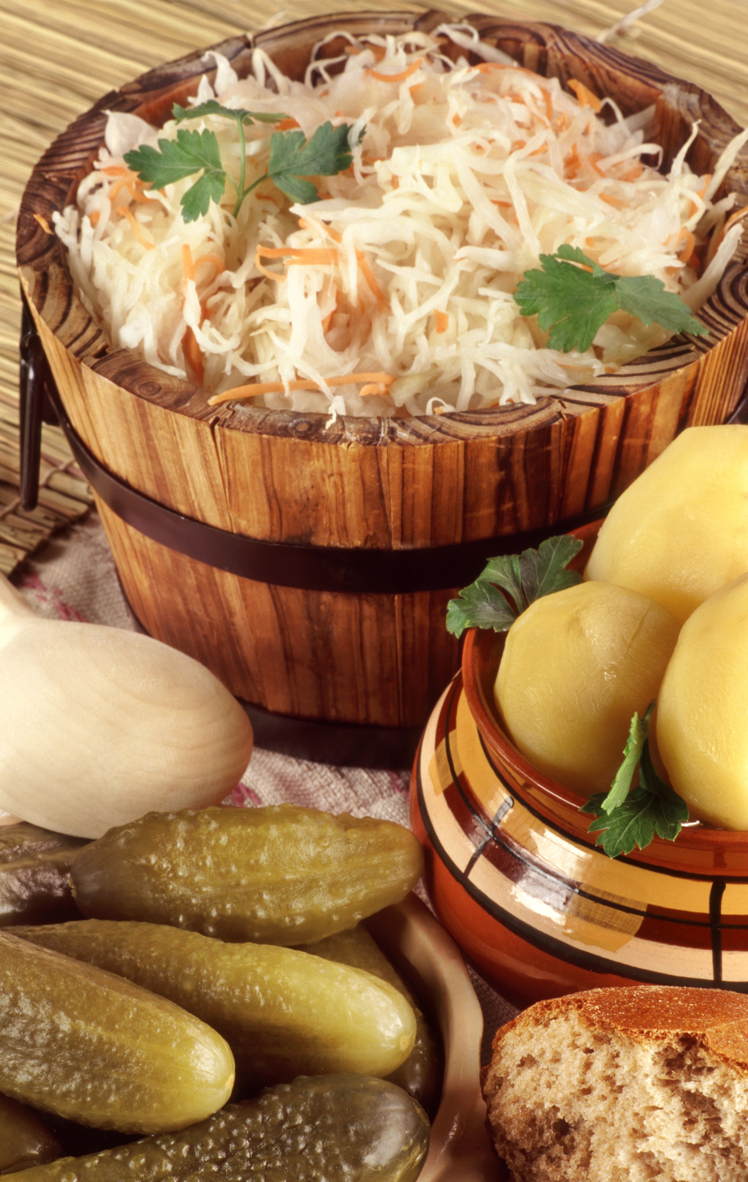 Sauerkraut, Potatoes, Pickles, and Bread in a Rustic Setting HD Phone Wallpaper