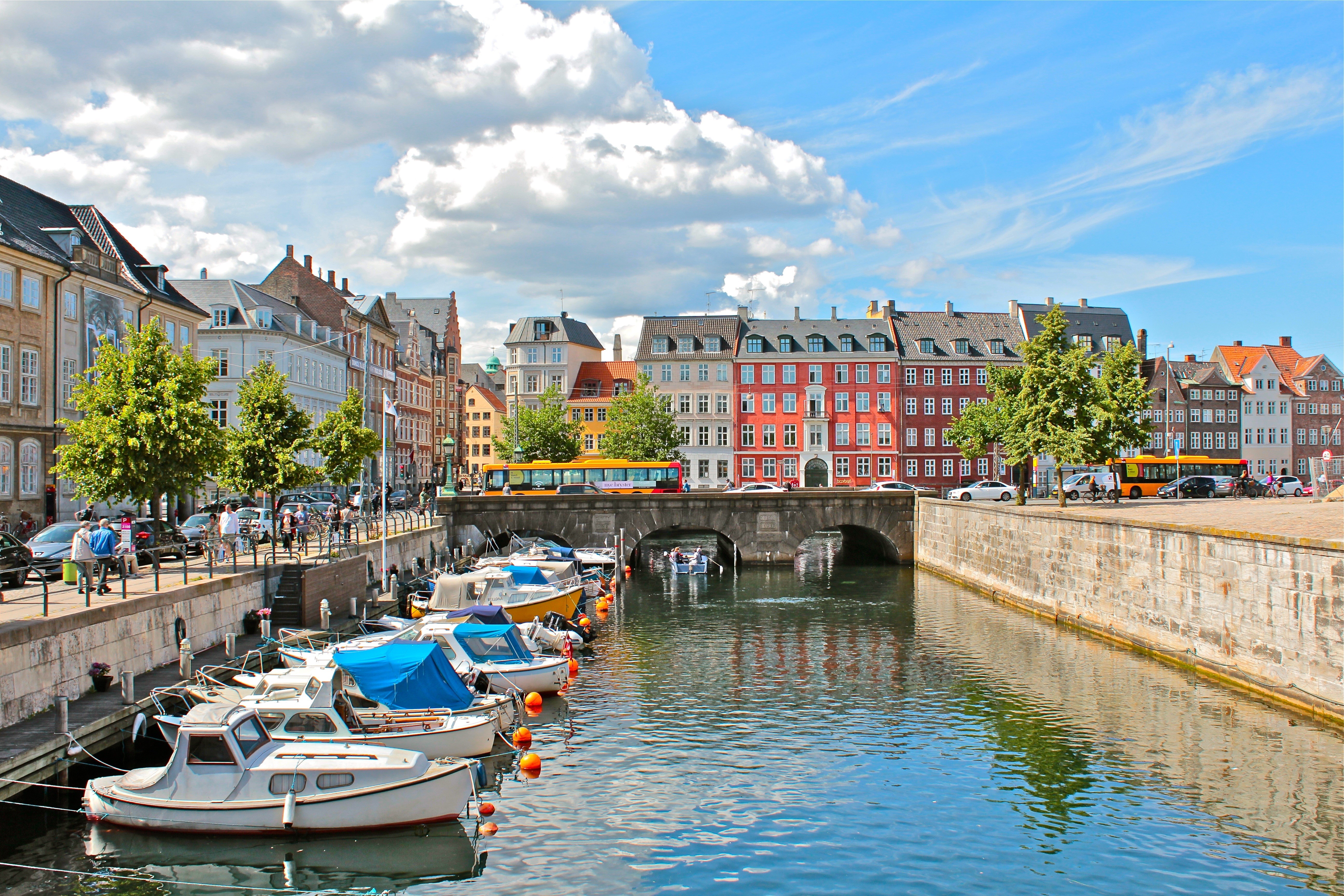 Canal in Copenhagen, Denmark with boats and buildings HD Wallpaper