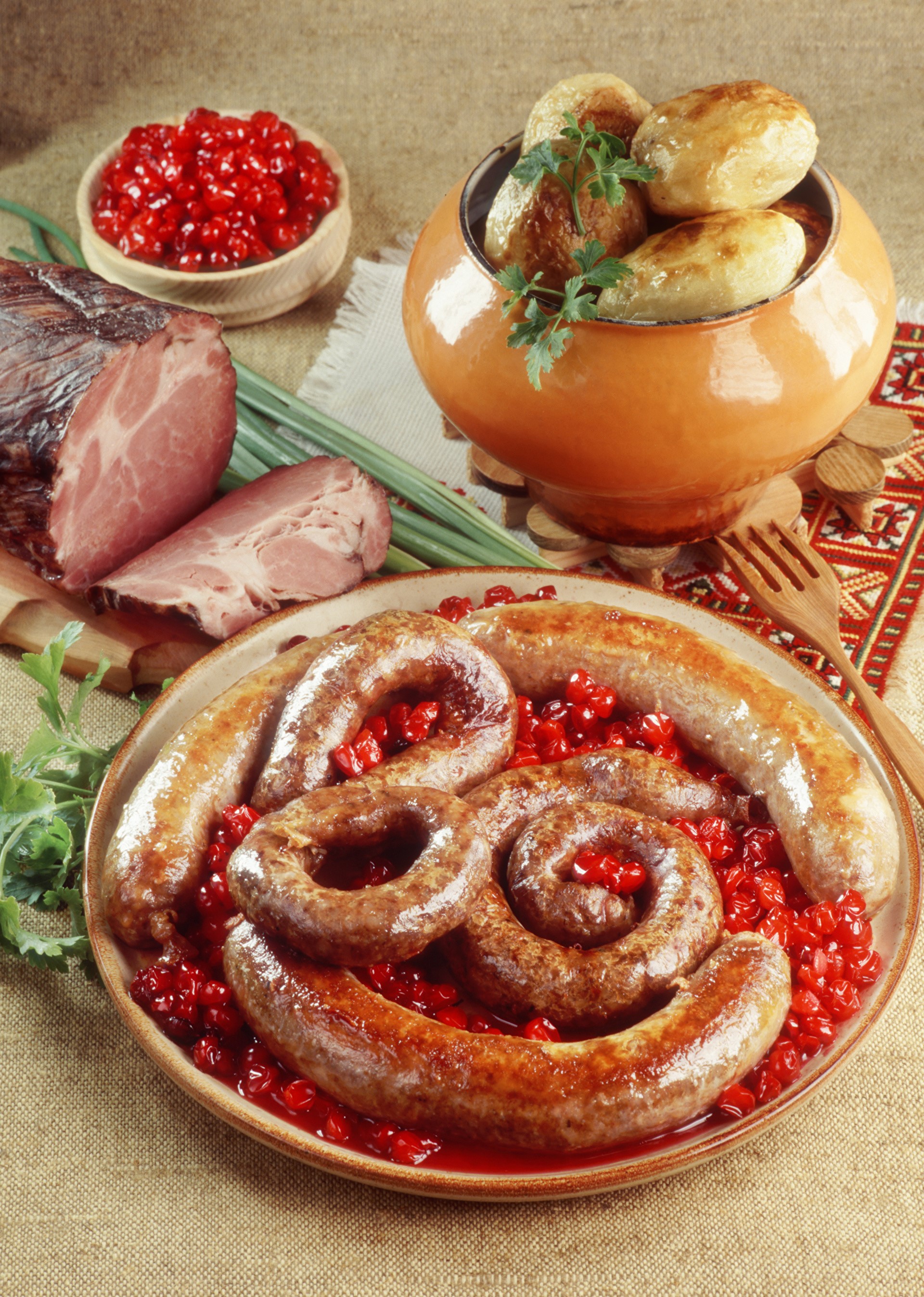 Sausages, ham, and potatoes with red berries HD Phone Wallpaper