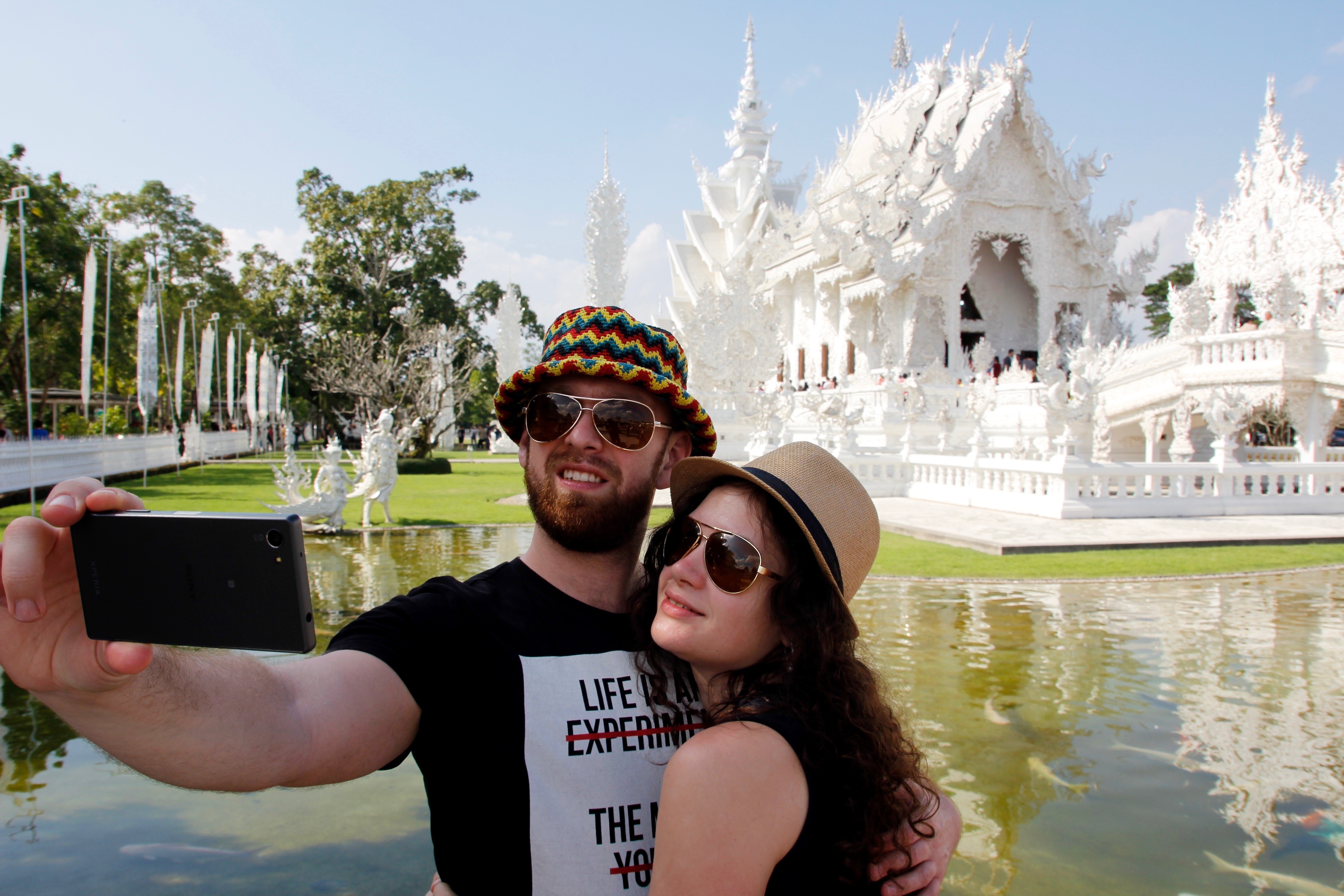 Couple taking a selfie at the White Temple, Thailand HD Wallpaper