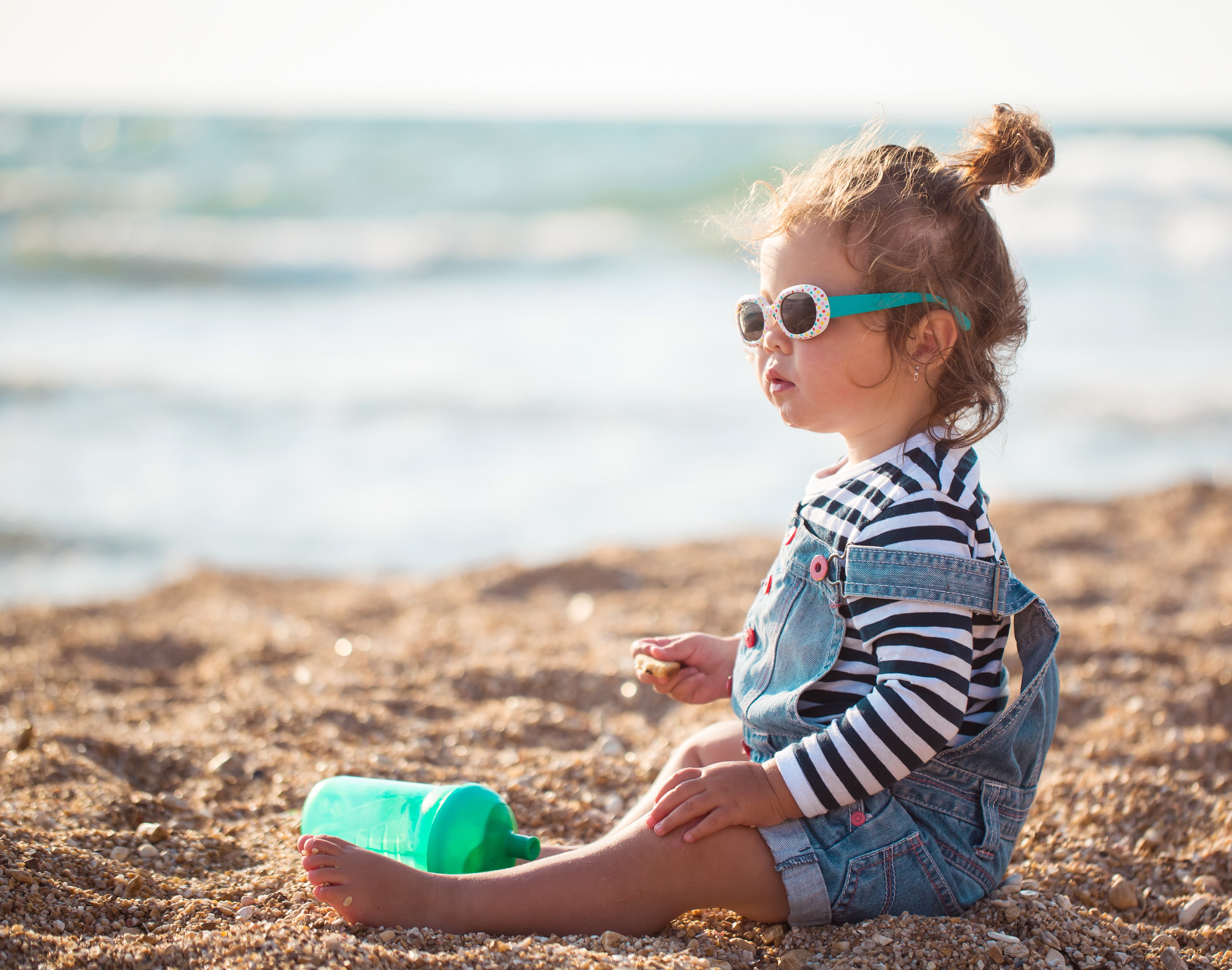 Little girl with sunglasses on the beach HD Wallpaper