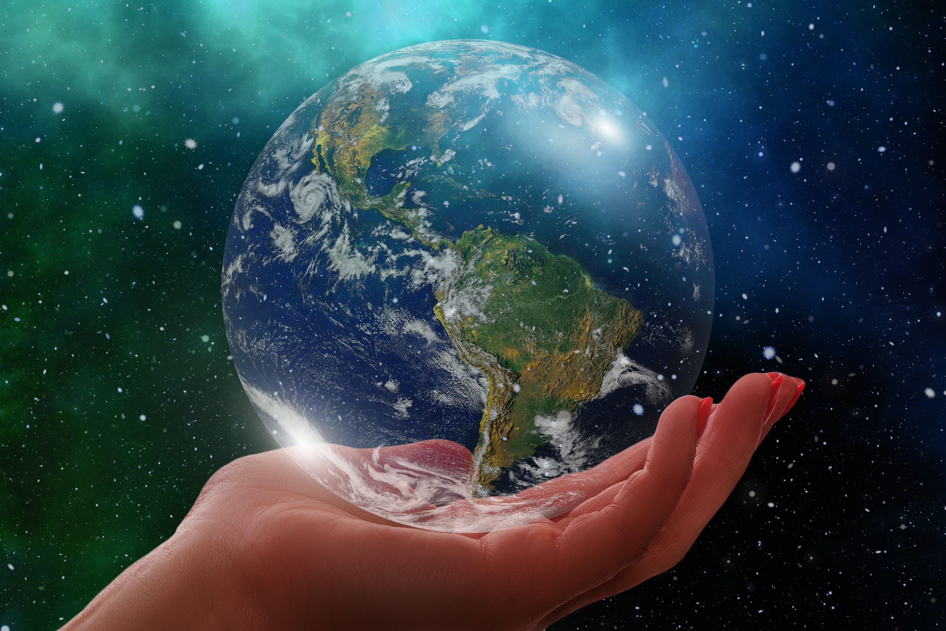 Hand holding the Earth in space HD Wallpaper