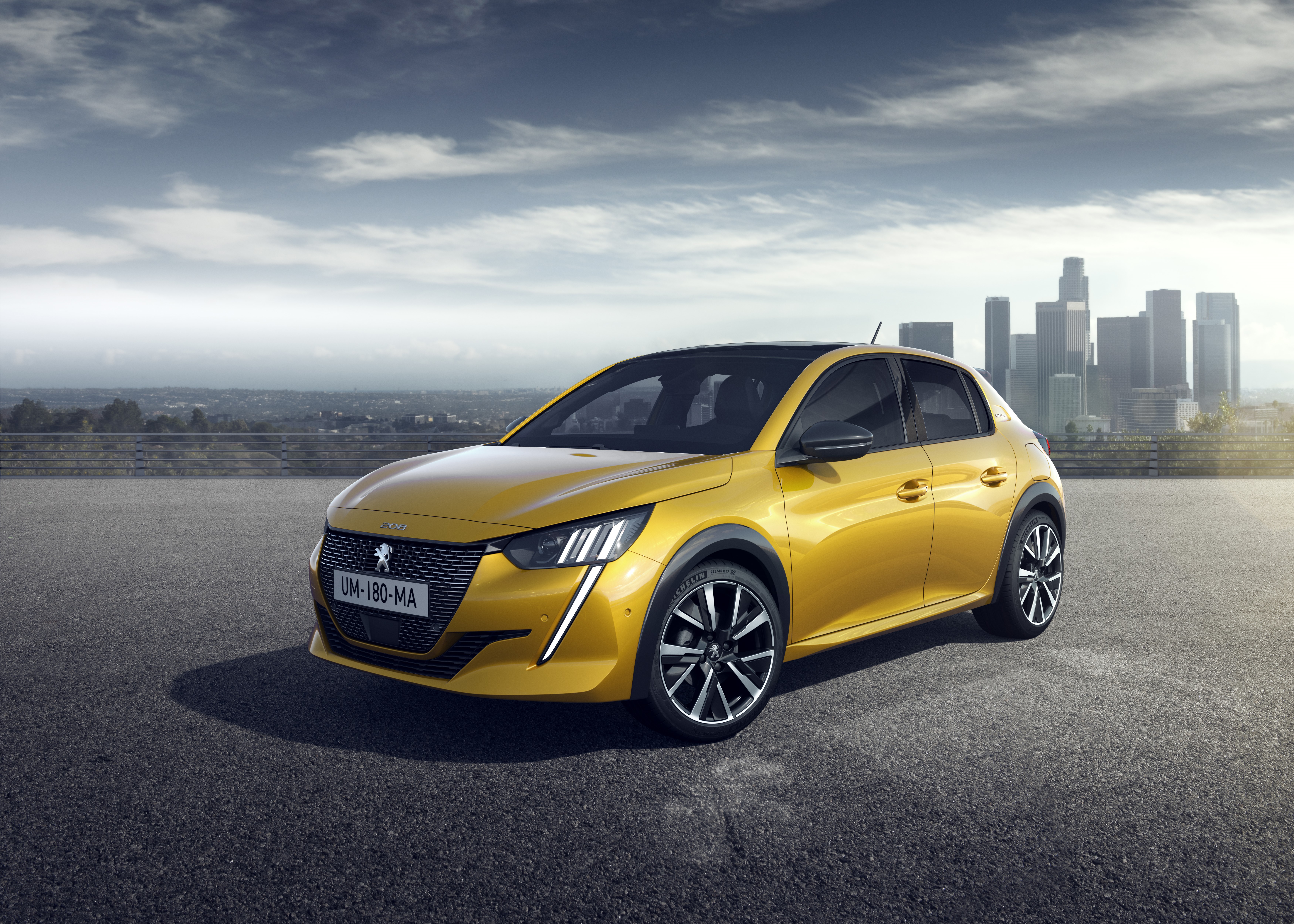 Yellow Peugeot 208 GT-Line with City Skyline HD Wallpaper