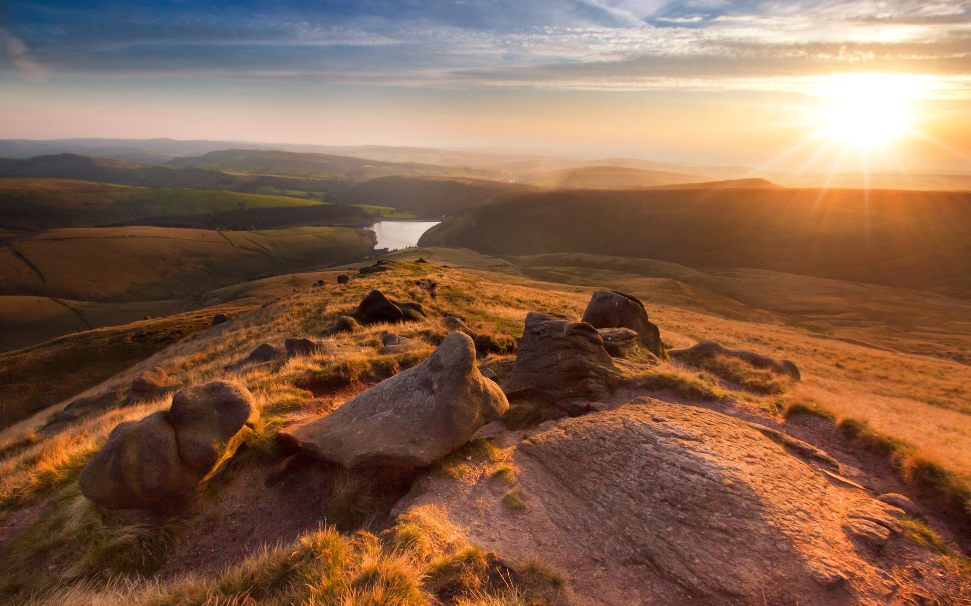 Sunset over rolling hills with a lake HD Wallpaper