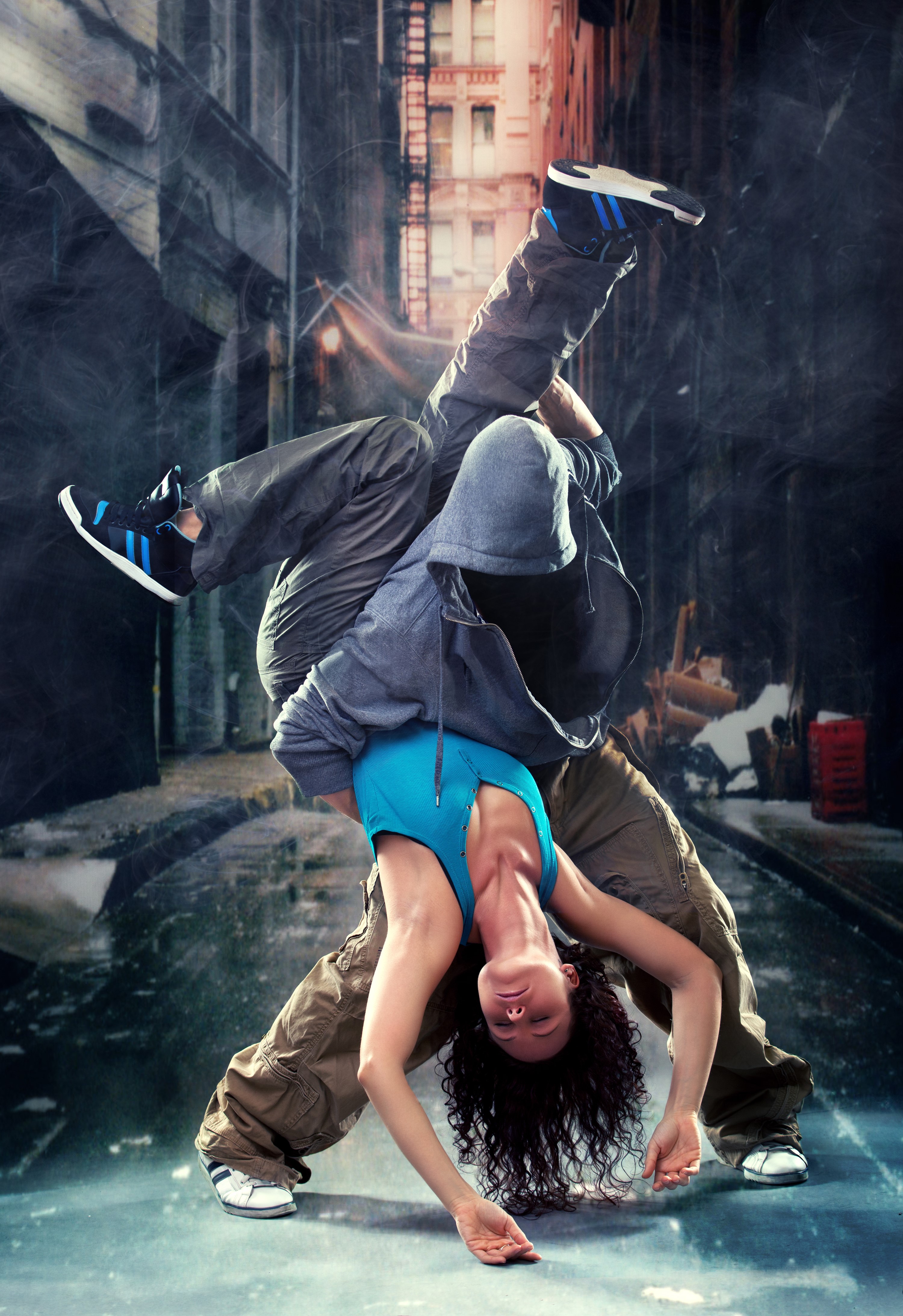 Two dancers performing a breakdance move in an urban setting HD Phone Wallpaper