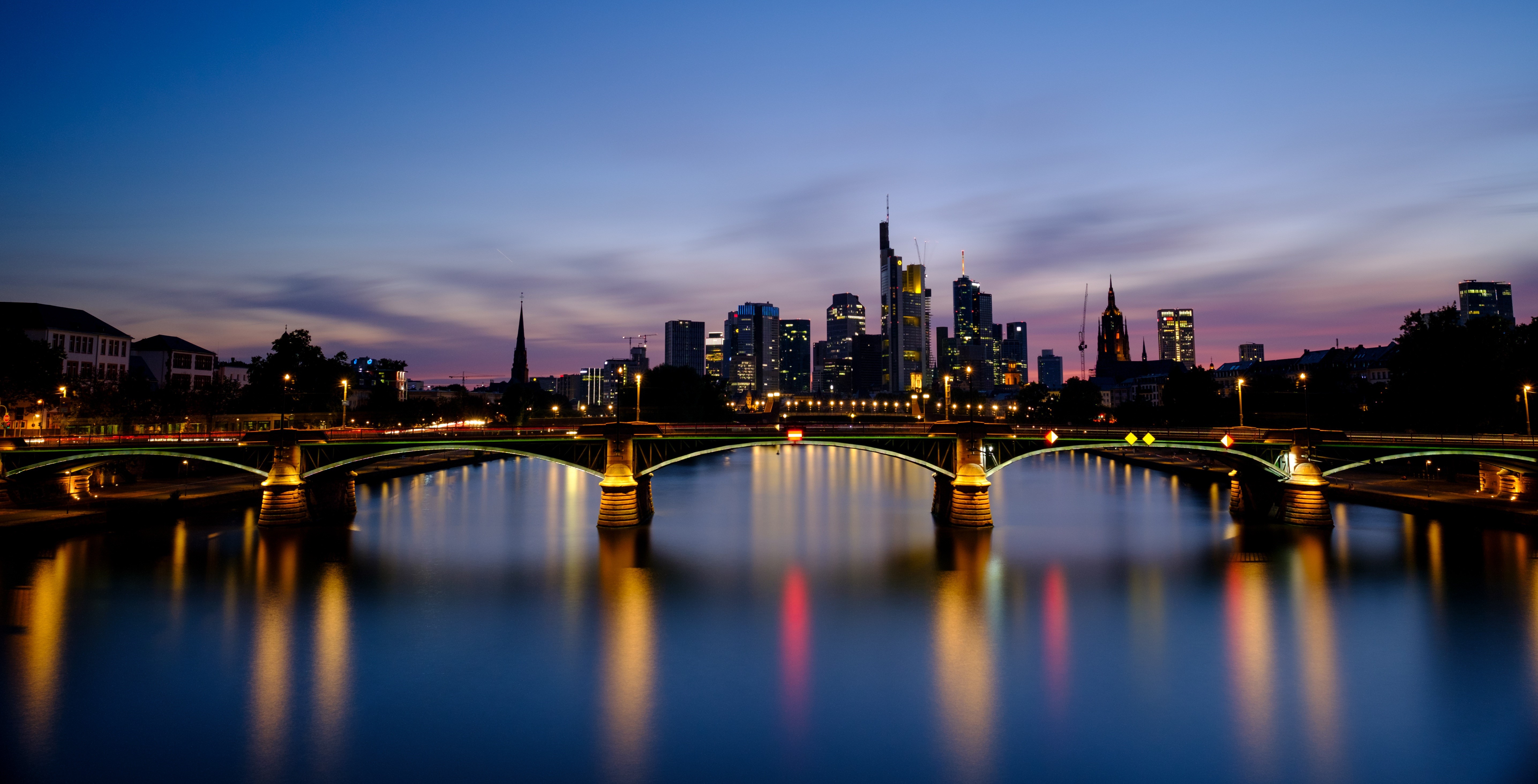 Frankfurt skyline and bridges over river at dusk HD Wallpaper