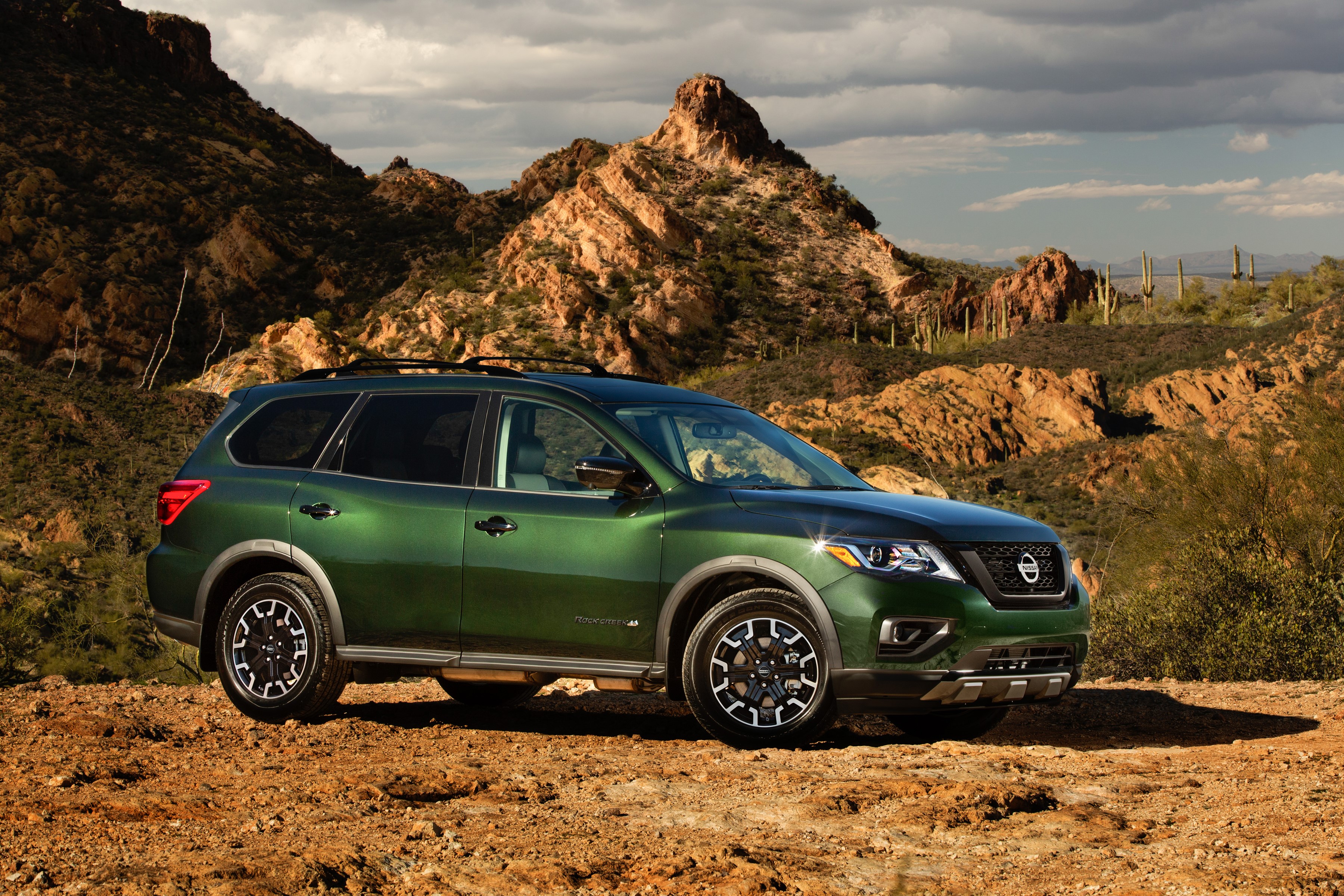 Green 2019 Nissan Pathfinder Rock Creek in desert landscape HD Wallpaper