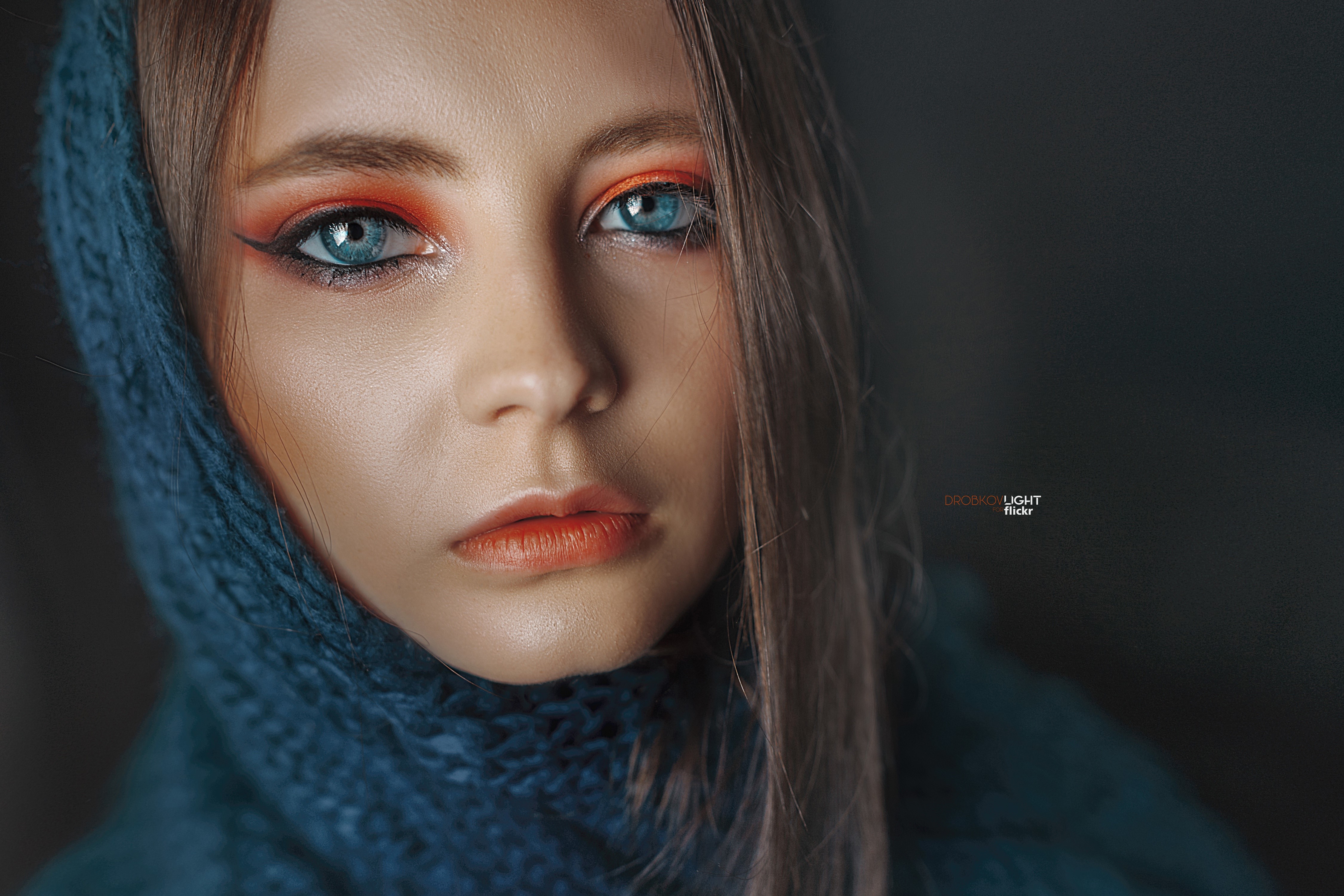 4K Portrait of a Woman with Blue Eyes and Orange Makeup HD Wallpaper