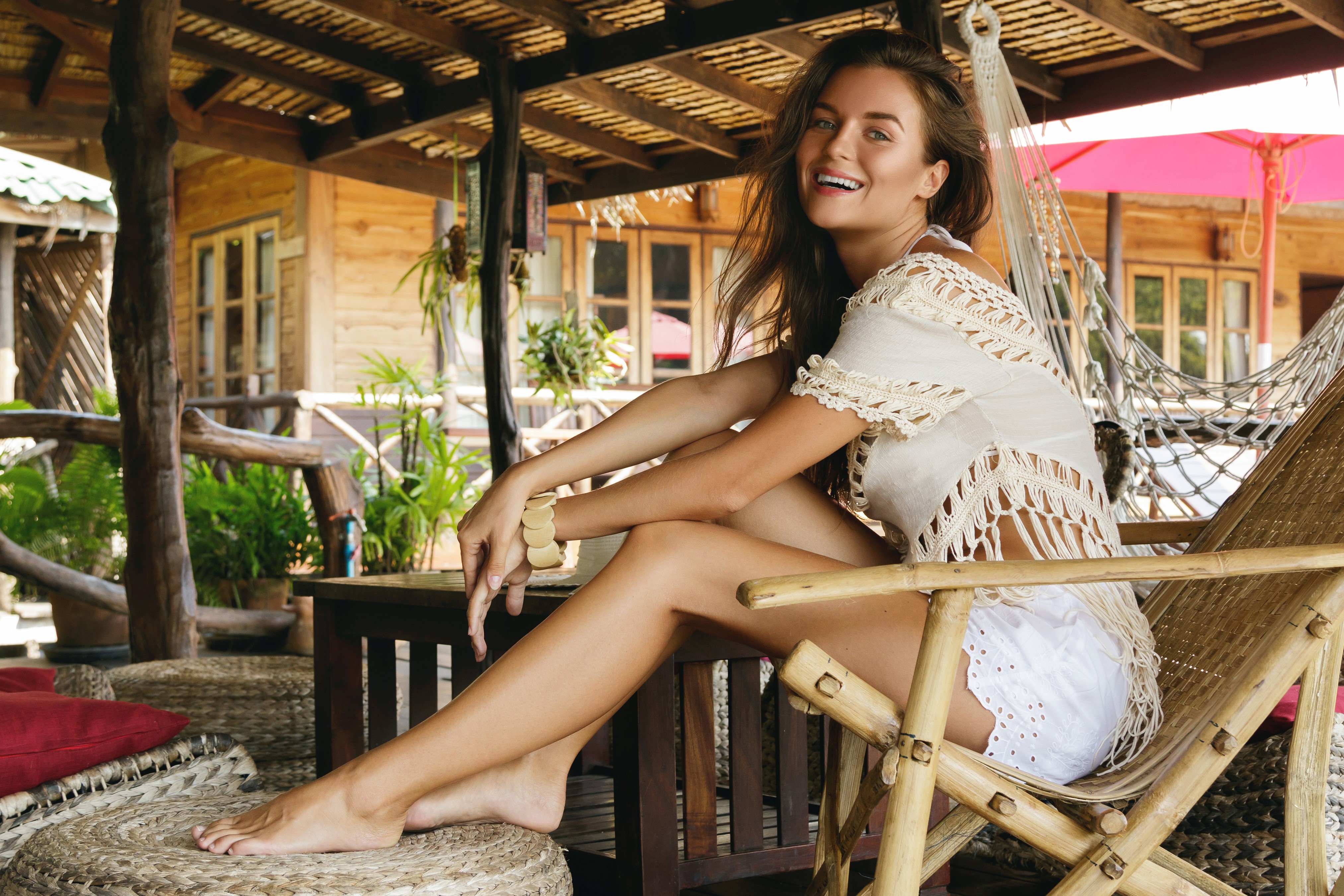 Woman with brown hair sitting in a chair and smiling HD Wallpaper