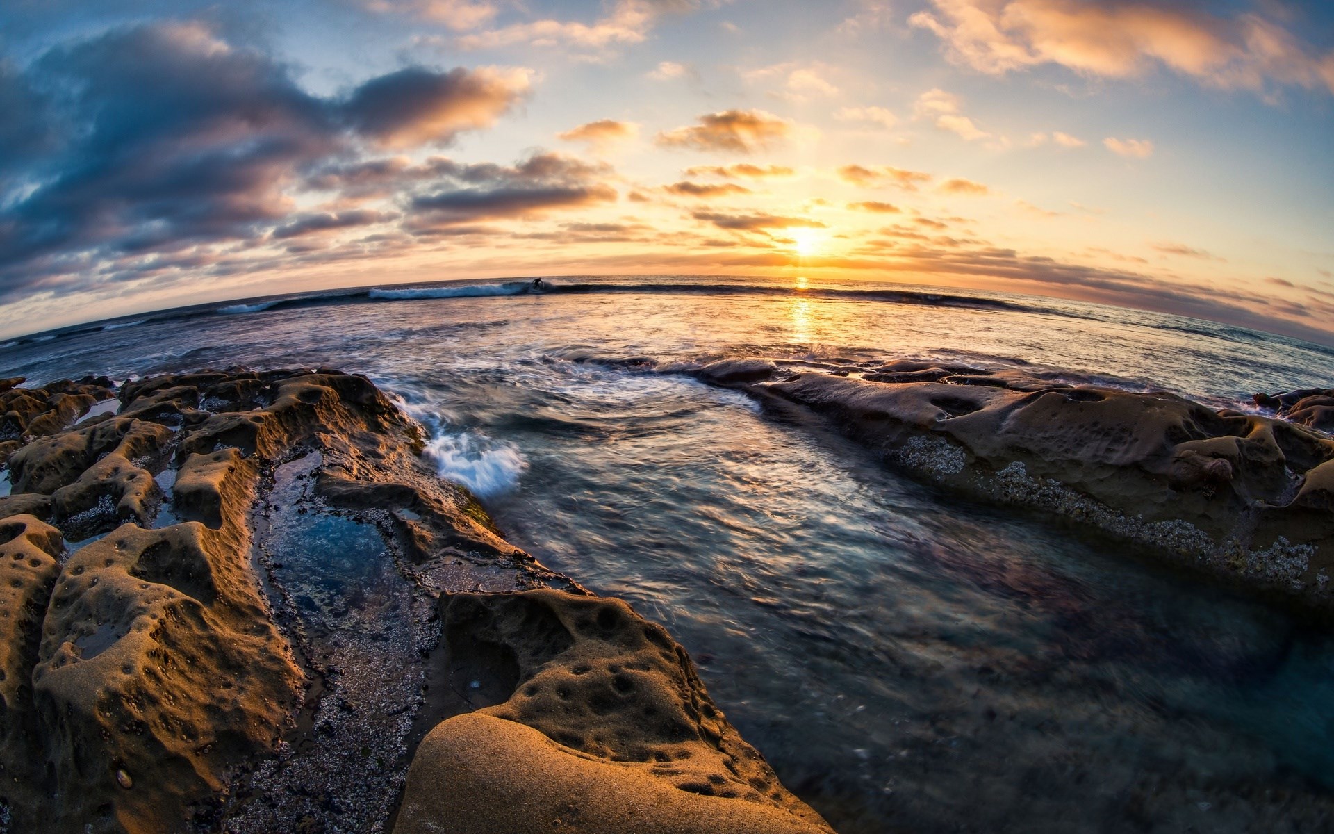 Sunset over the ocean with rocky shore HD Wallpaper