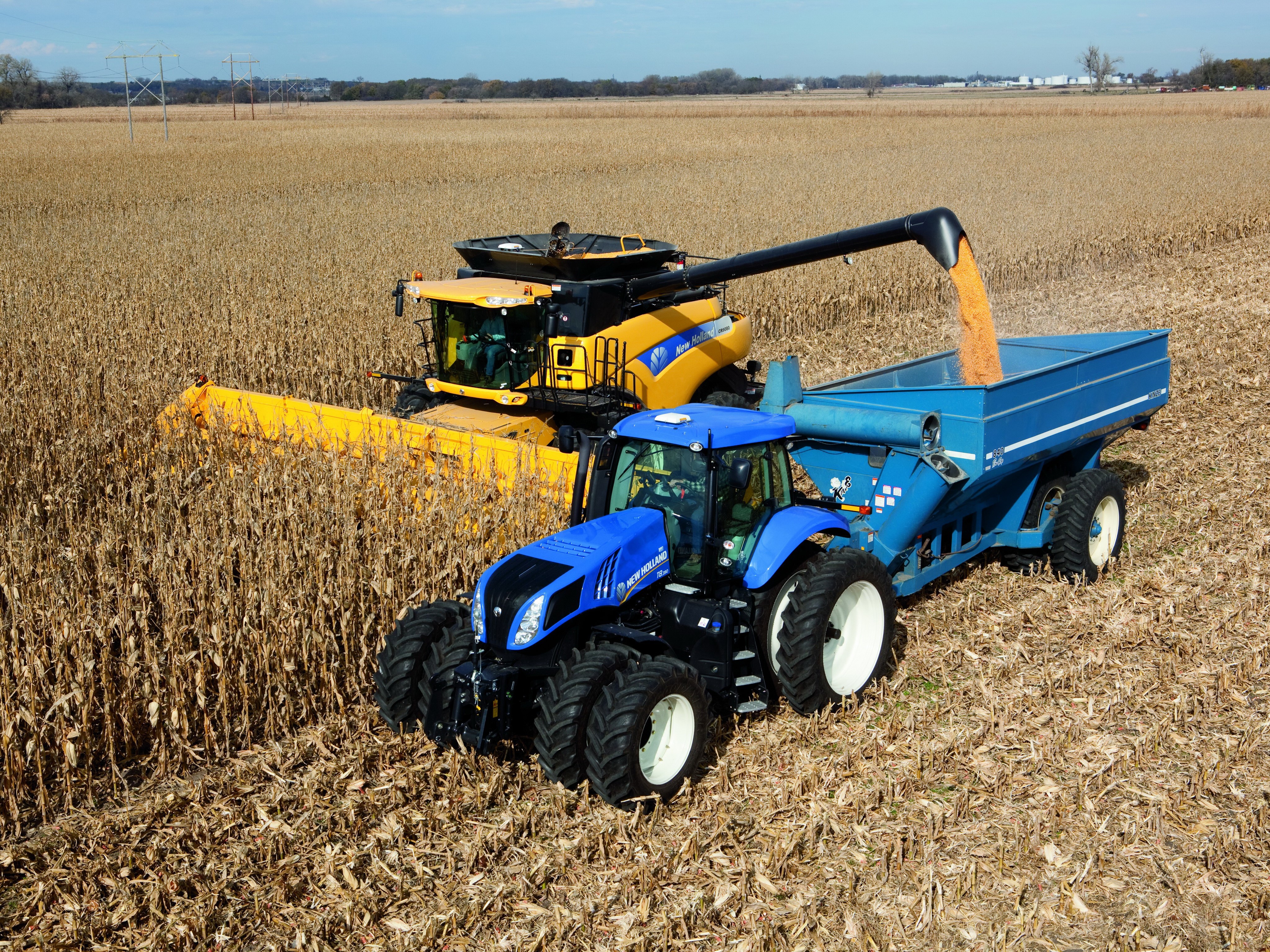 Combine harvester and tractor harvesting corn field HD Wallpaper