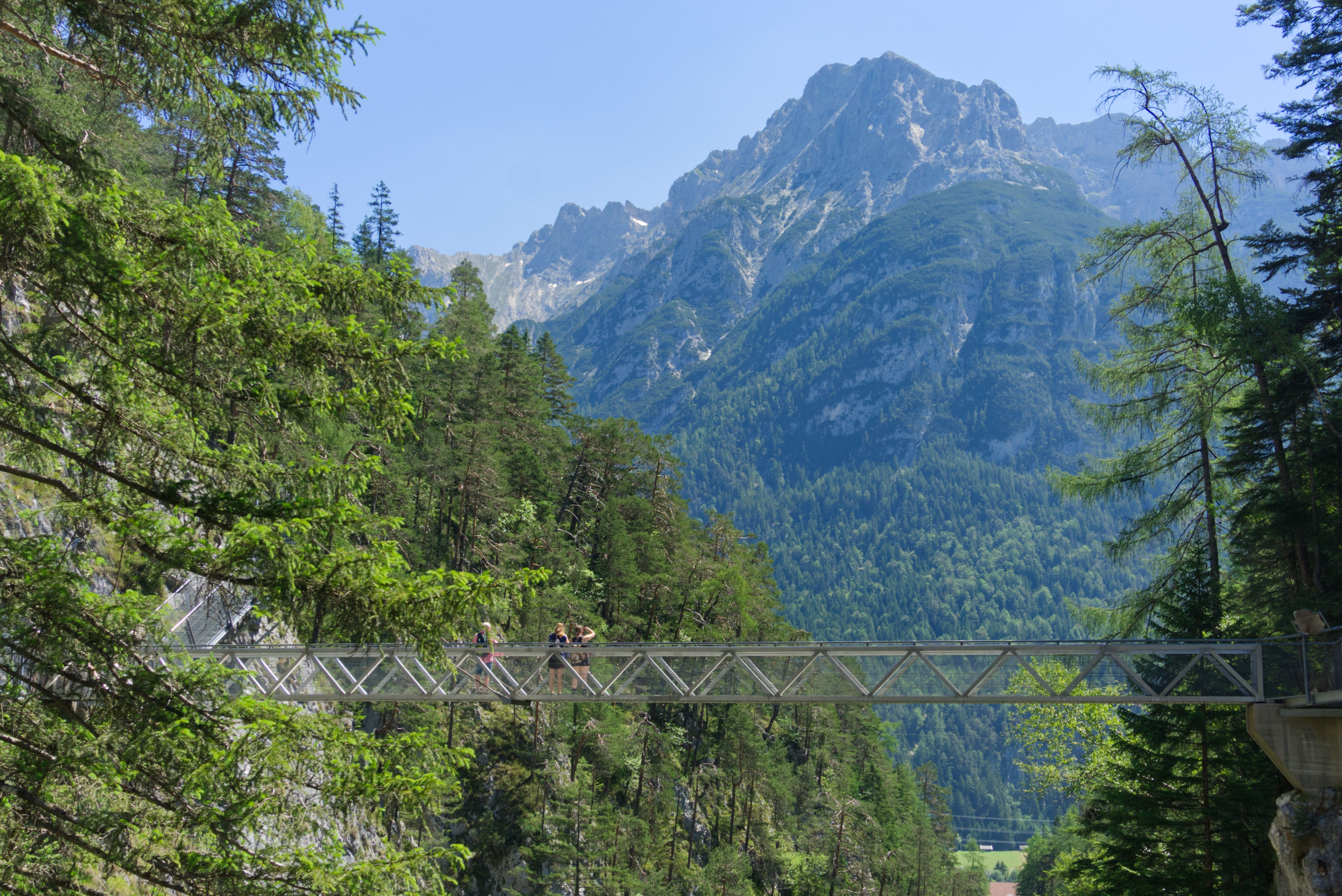 People on a bridge in a mountain gorge in Bavaria HD Wallpaper