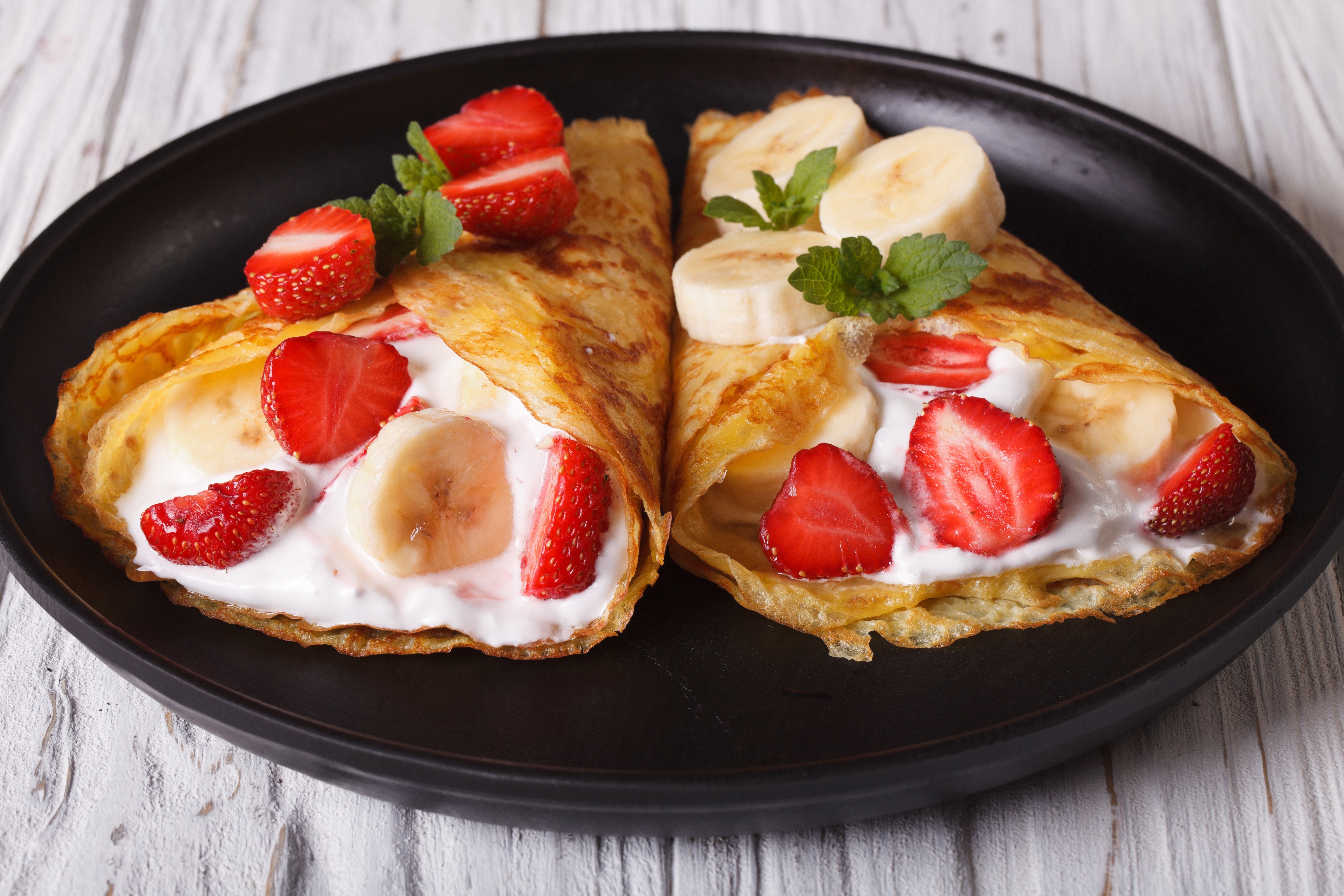 Crepes with Strawberries, Bananas, and Cream on a Plate HD Wallpaper