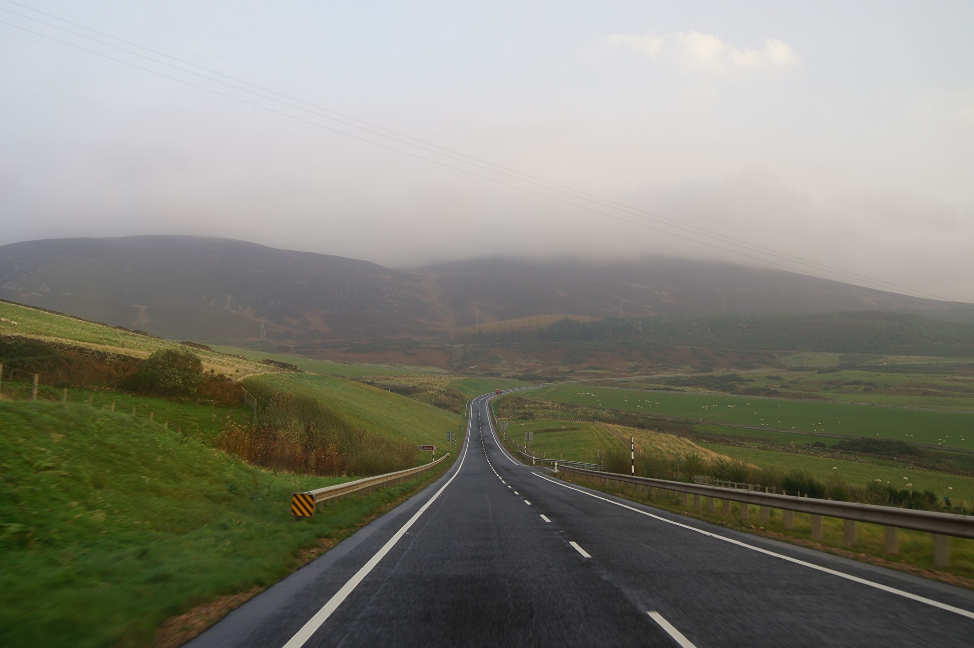 Road through foggy hills HD Wallpaper