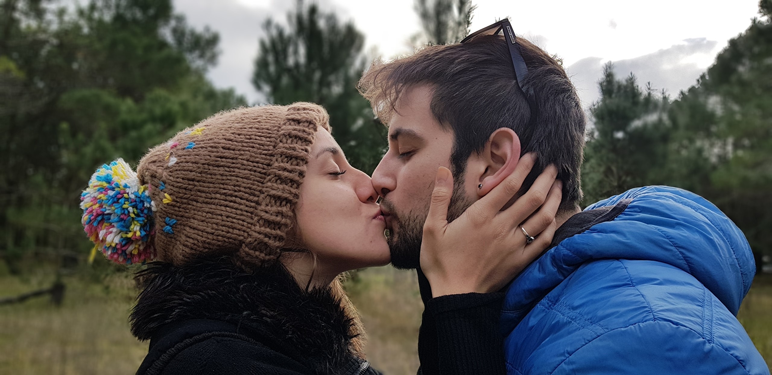 Couple kissing in a forest HD Wallpaper