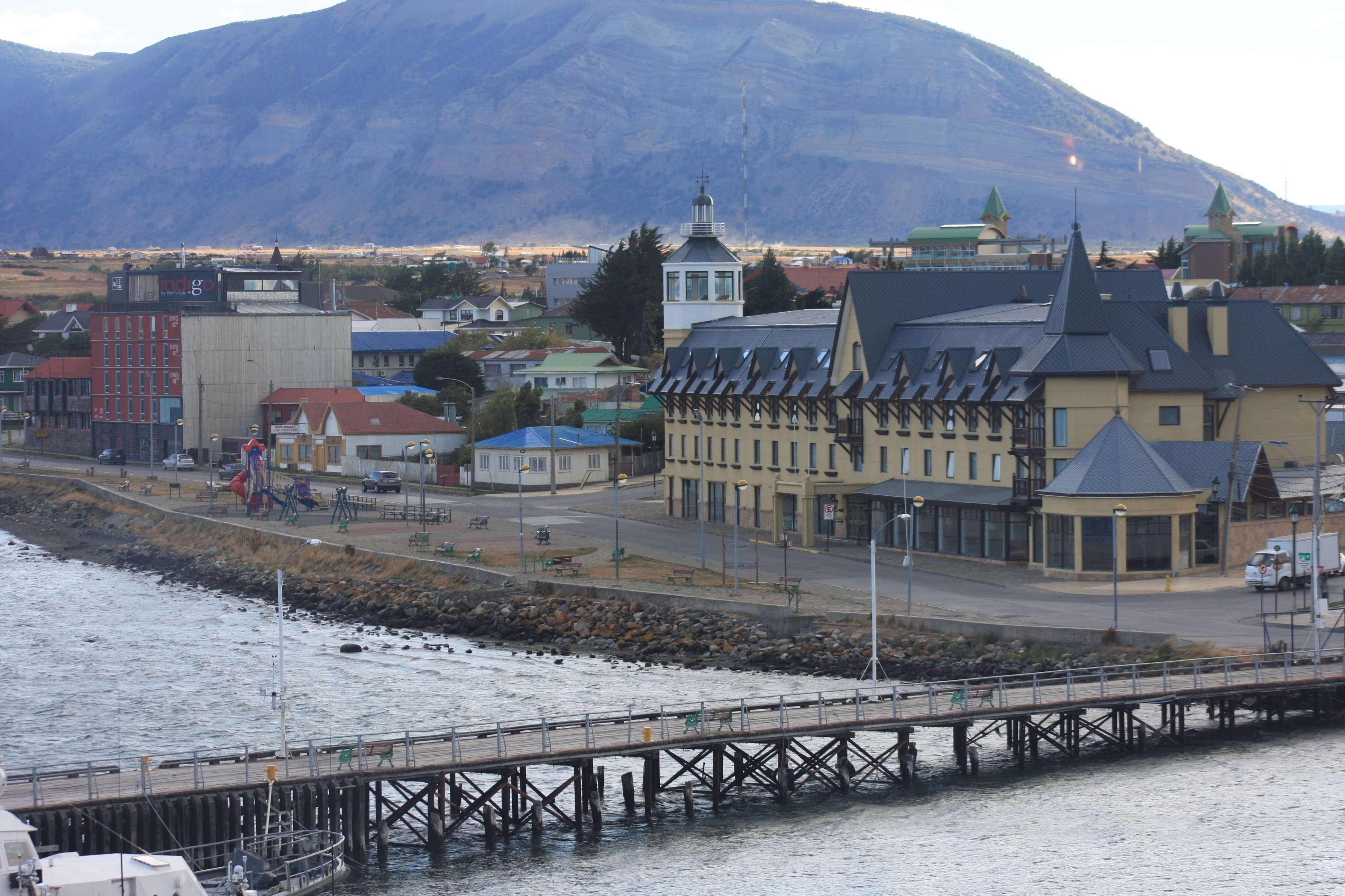 Punta Arenas waterfront with buildings and mountains HD Wallpaper