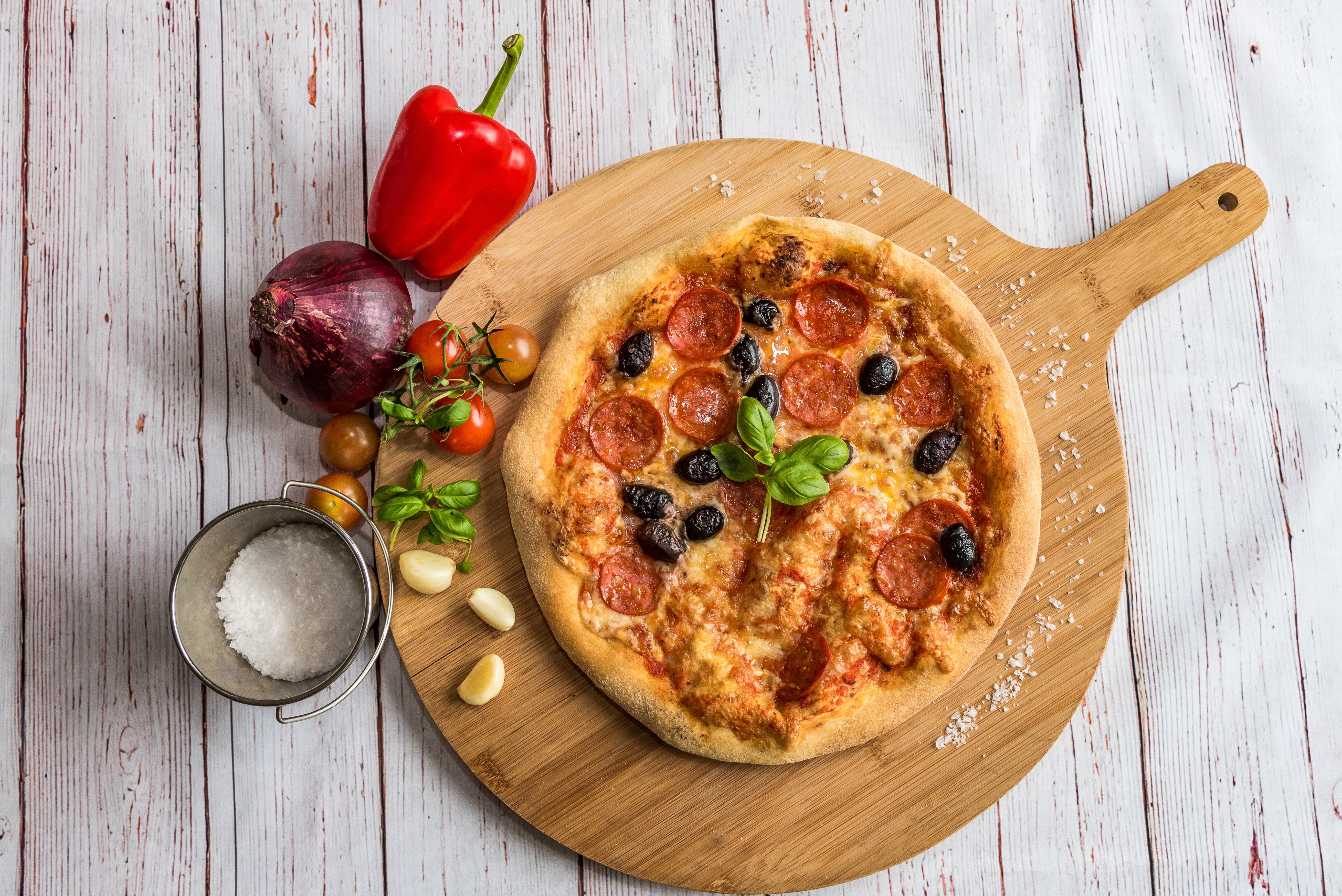 Pepperoni Pizza with Olives and Basil on Cutting Board HD Wallpaper