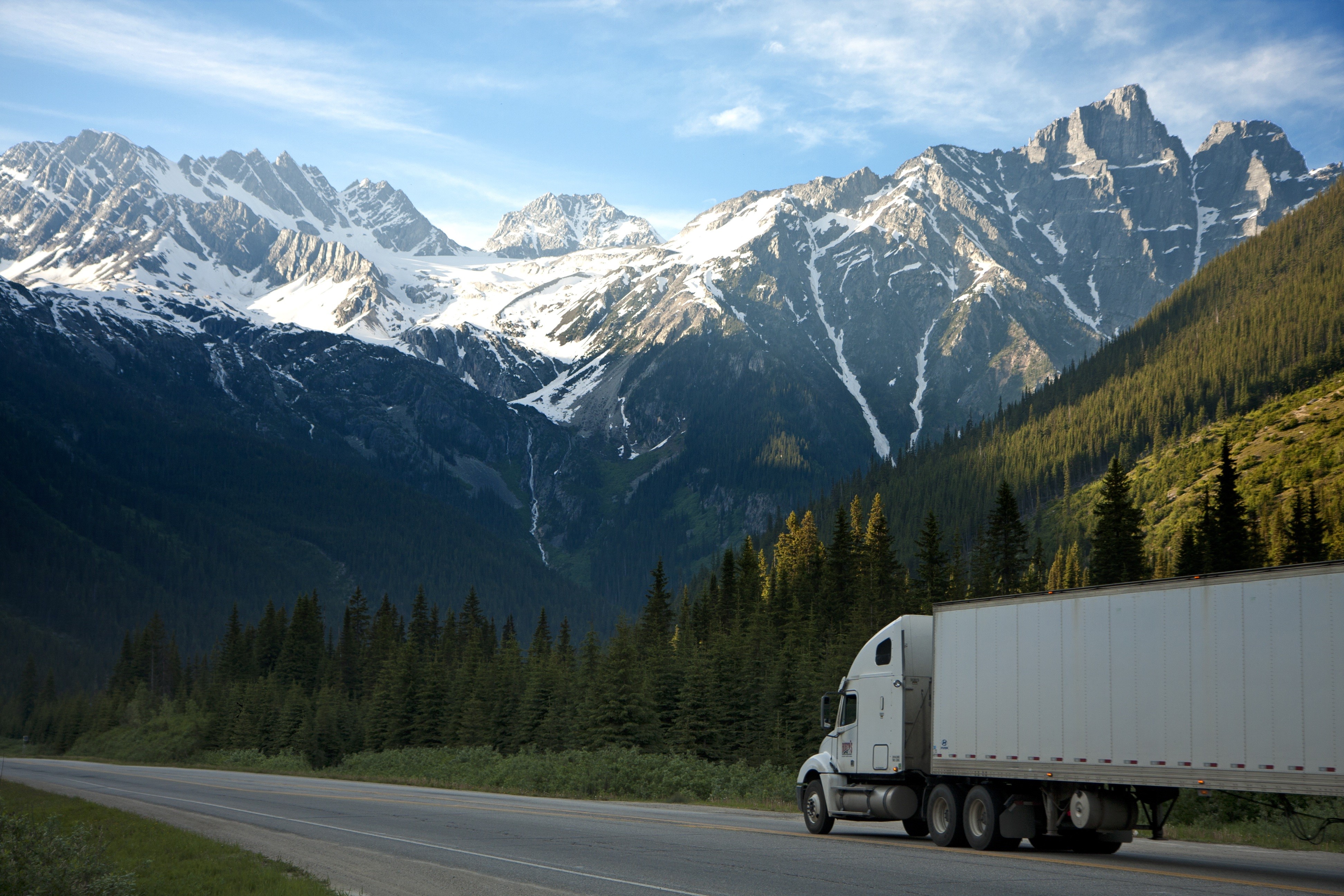 Truck on a road in Canadian Rocky Mountains HD Wallpaper
