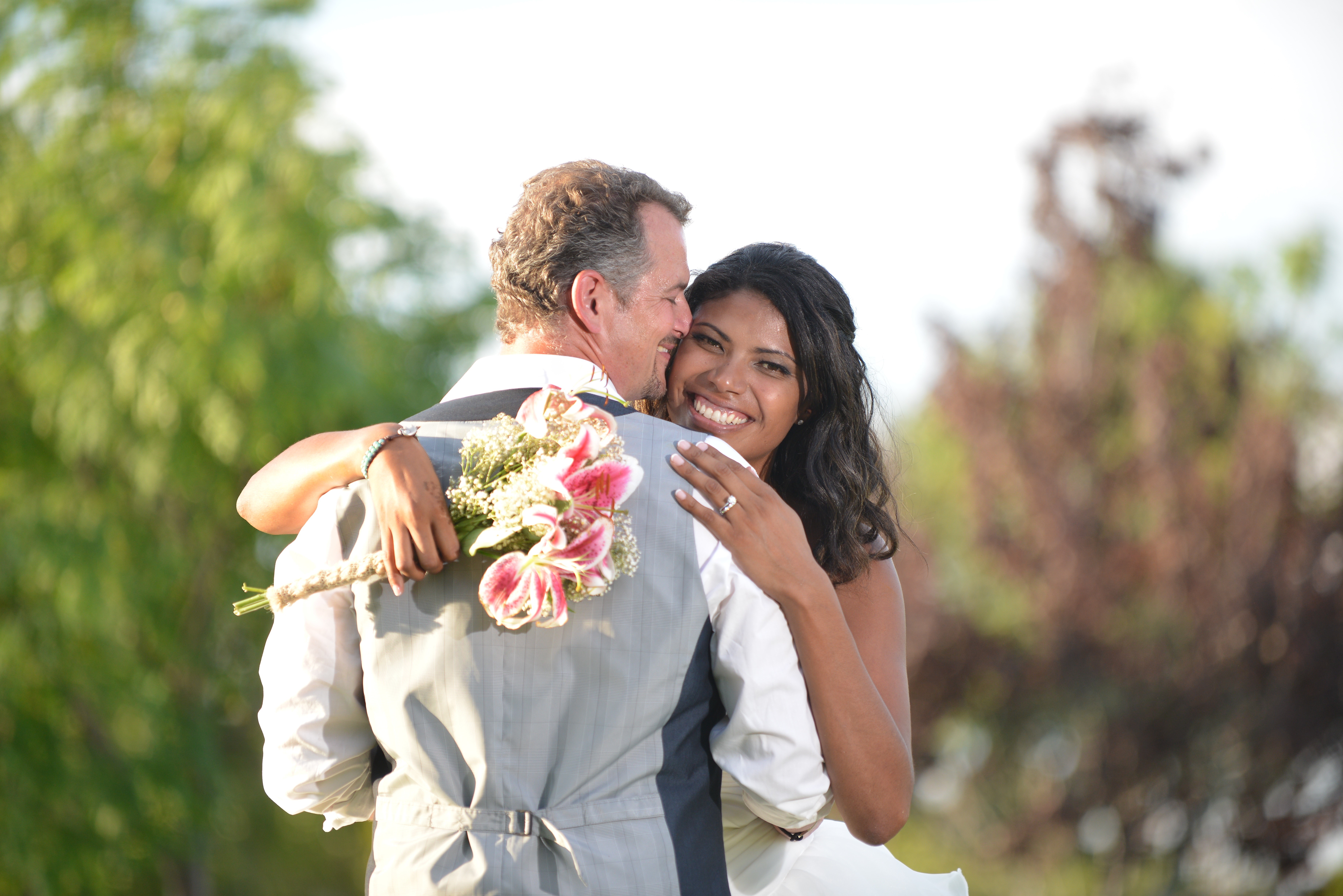 Bride and Groom Hugging with Bouquet HD Wallpaper