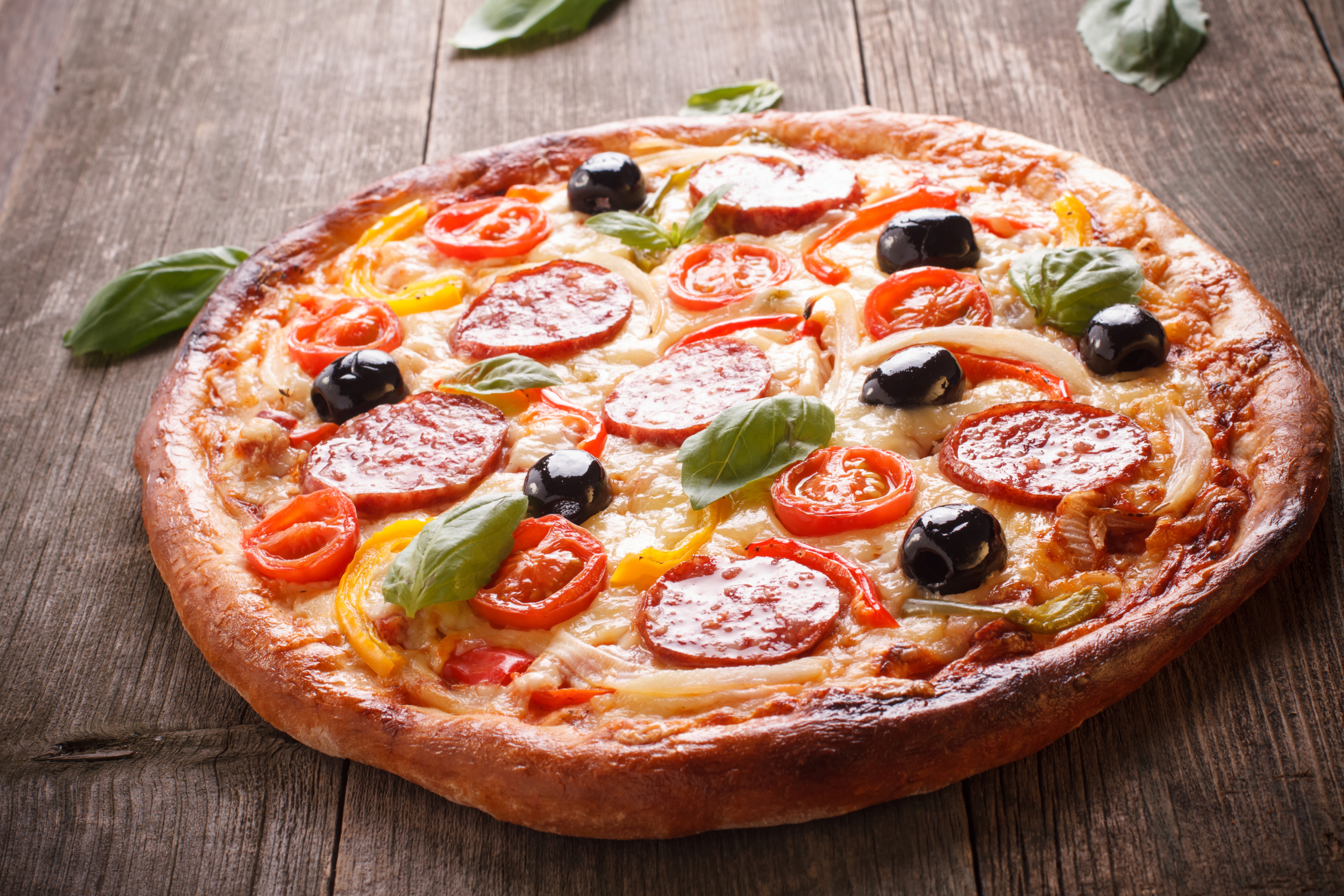 Pizza with Sausage, Olives, and Tomatoes on Wood HD Wallpaper