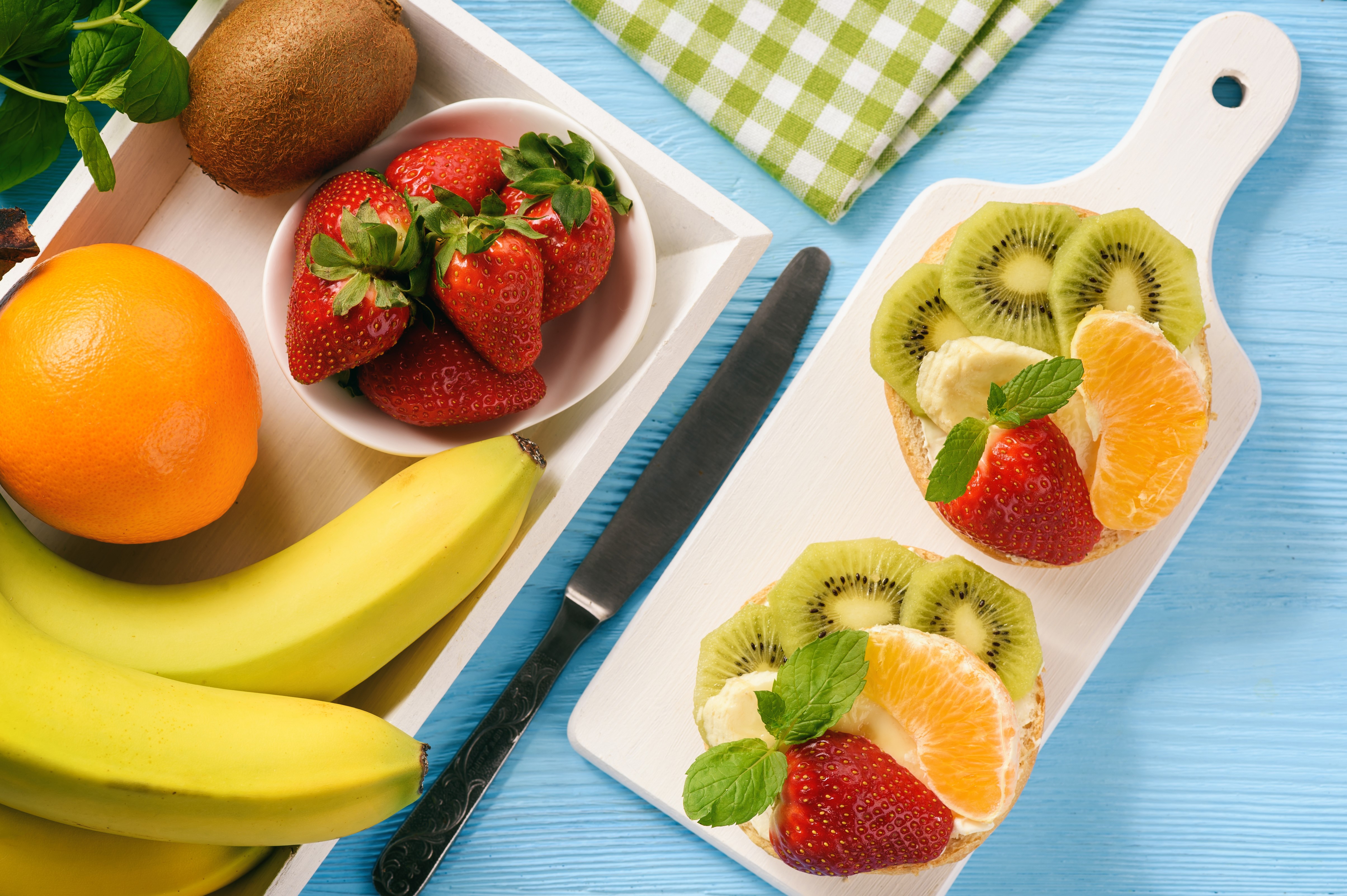 Fruit platter with strawberries, kiwi, orange, and bananas HD Wallpaper