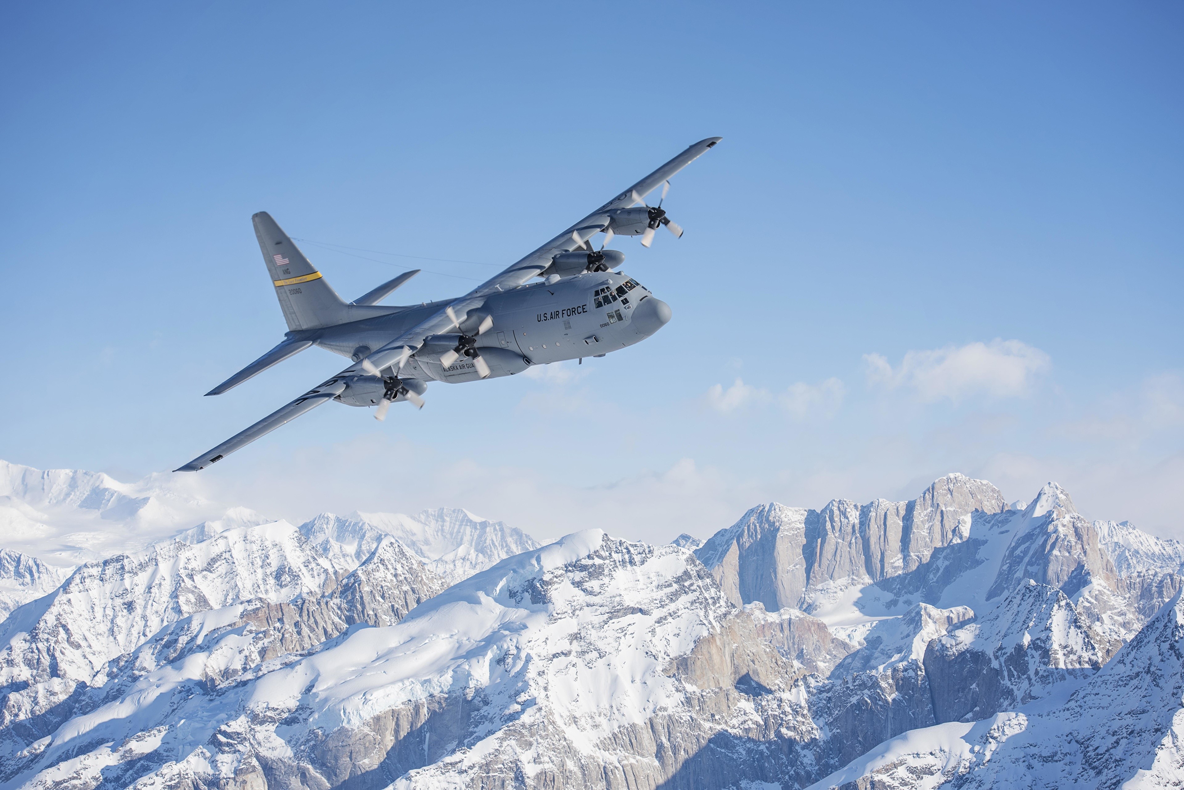 C-130 Hercules flying over snowy mountains HD Wallpaper