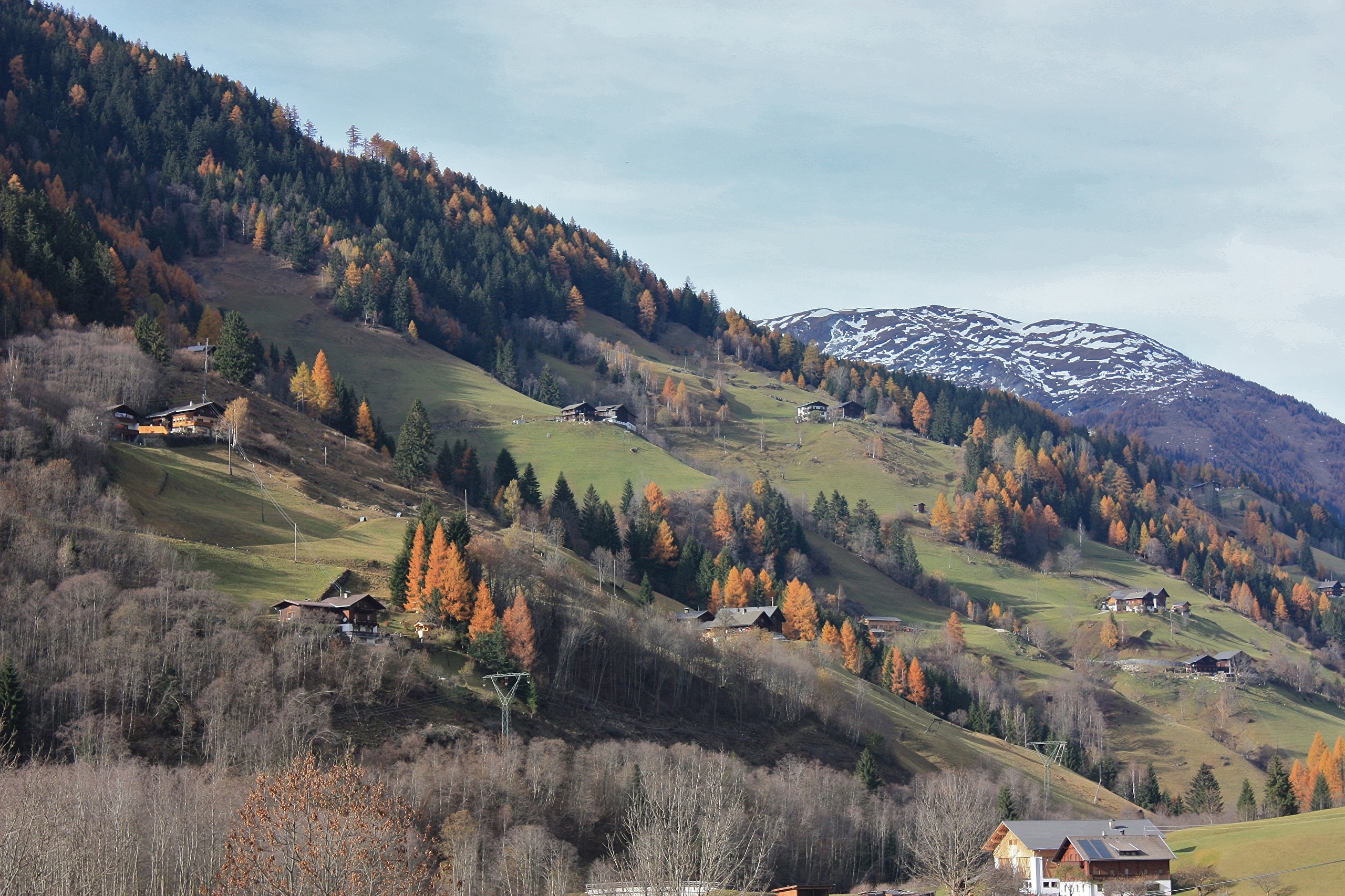 Autumn mountain village in Austria with snow-capped peaks HD Wallpaper