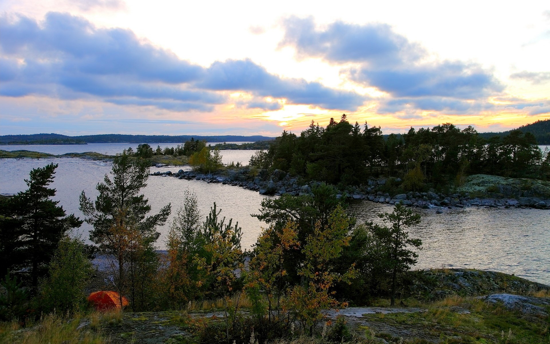 Sunset over a rocky island archipelago with a tent HD Wallpaper