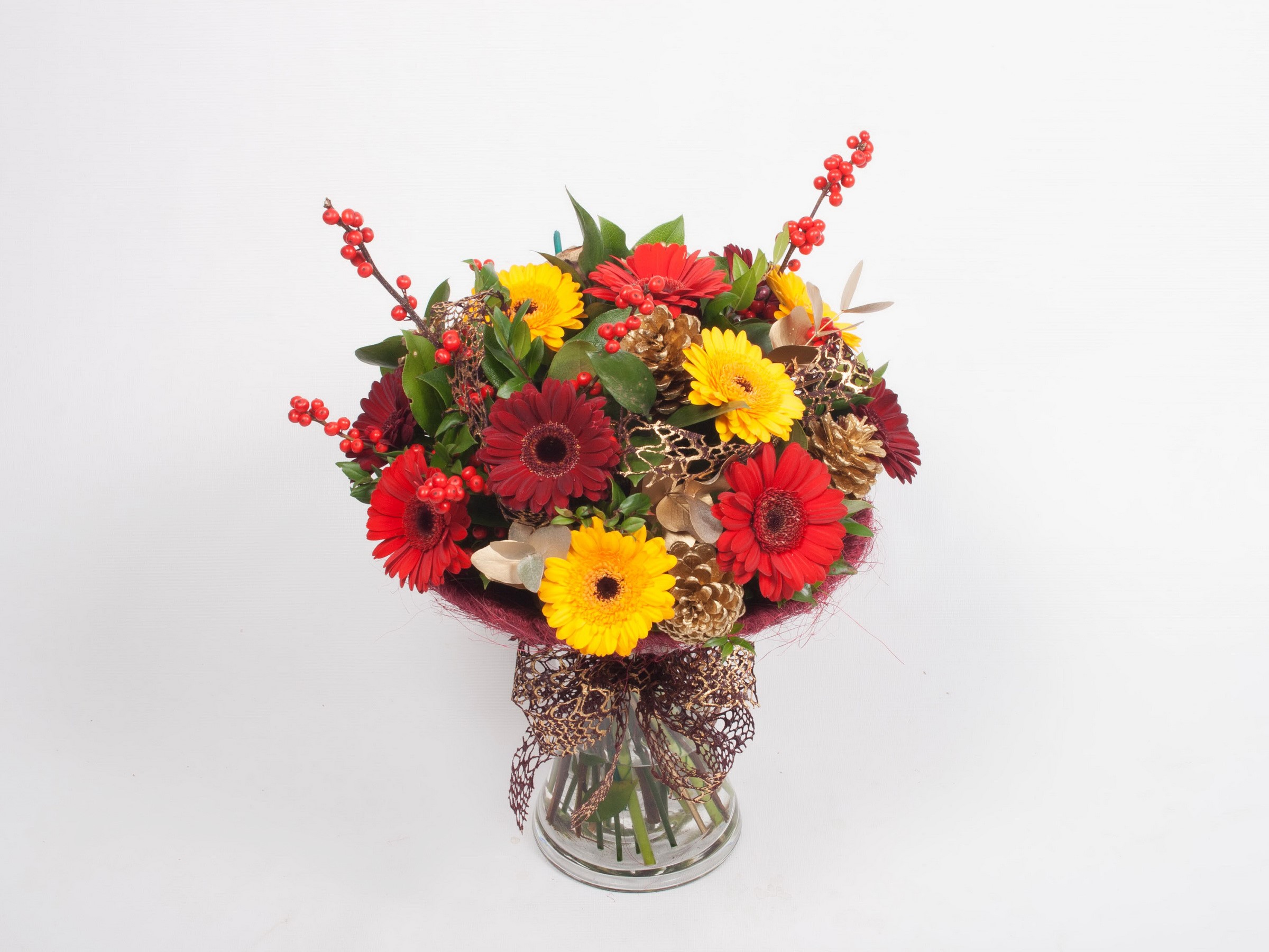 Red and yellow gerbera bouquet with pinecones and berries in a vase HD Wallpaper
