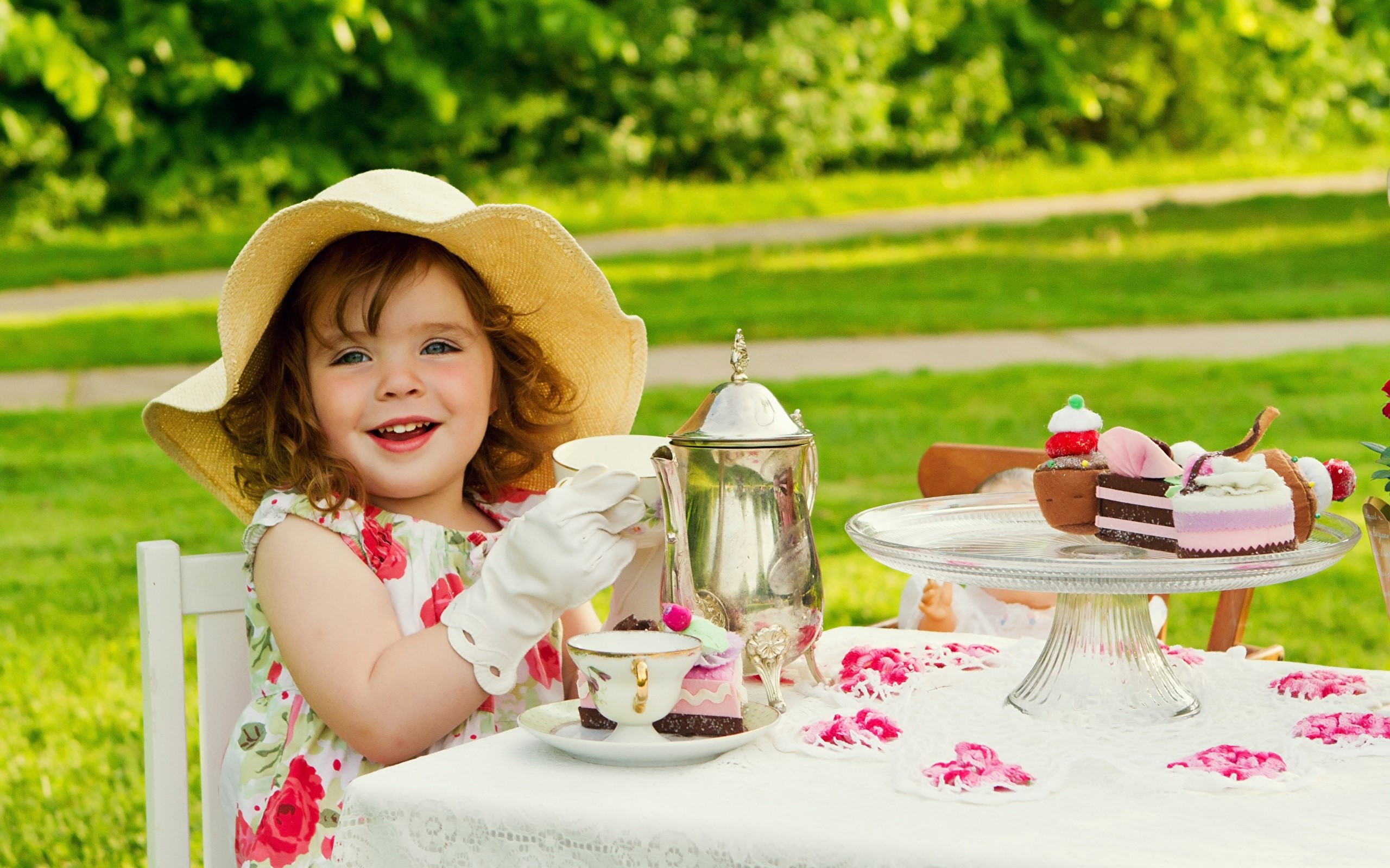 Girl in hat having a tea party with cakes HD Wallpaper