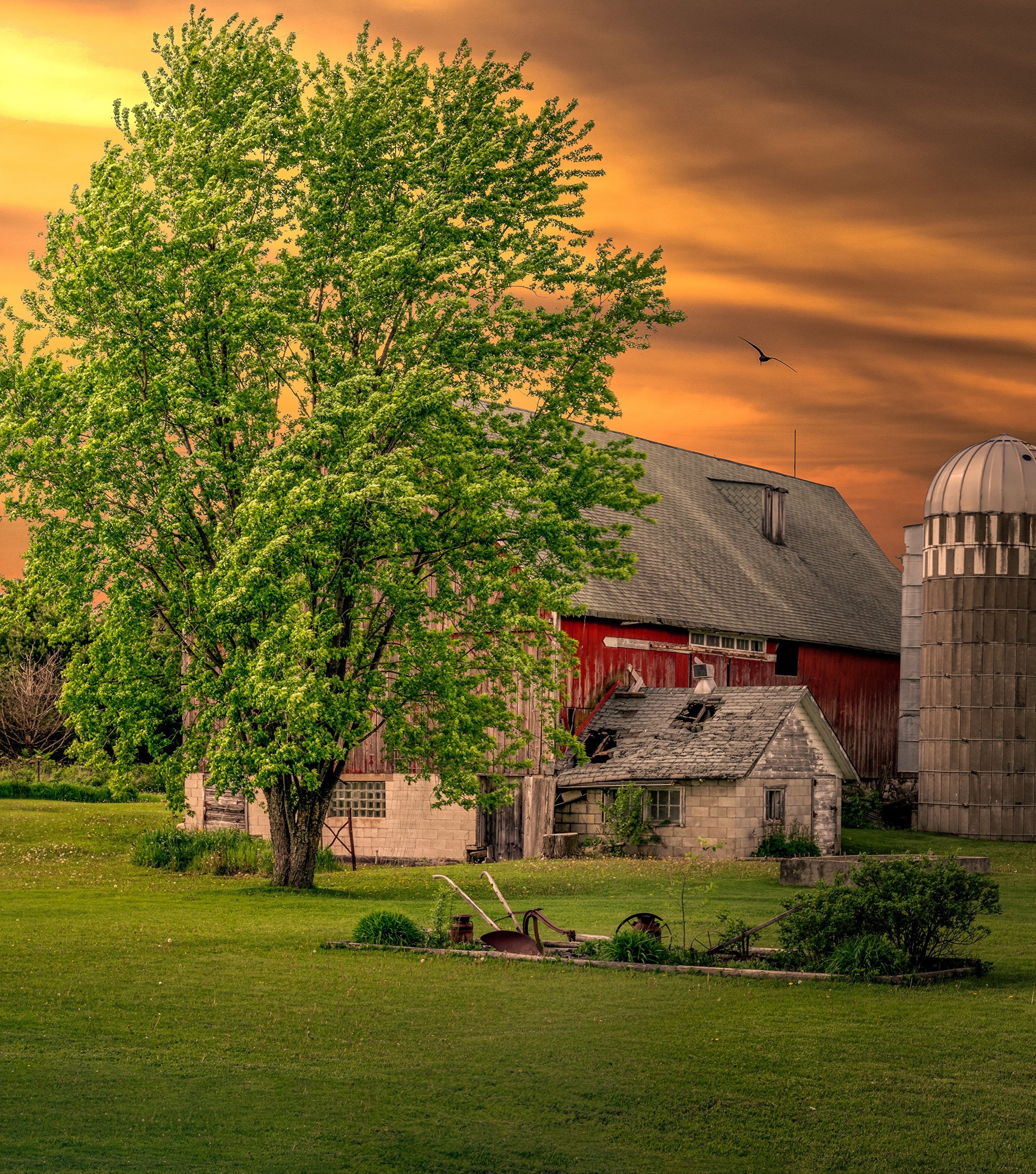 Farm with red barn and silo at sunset HD Wallpaper