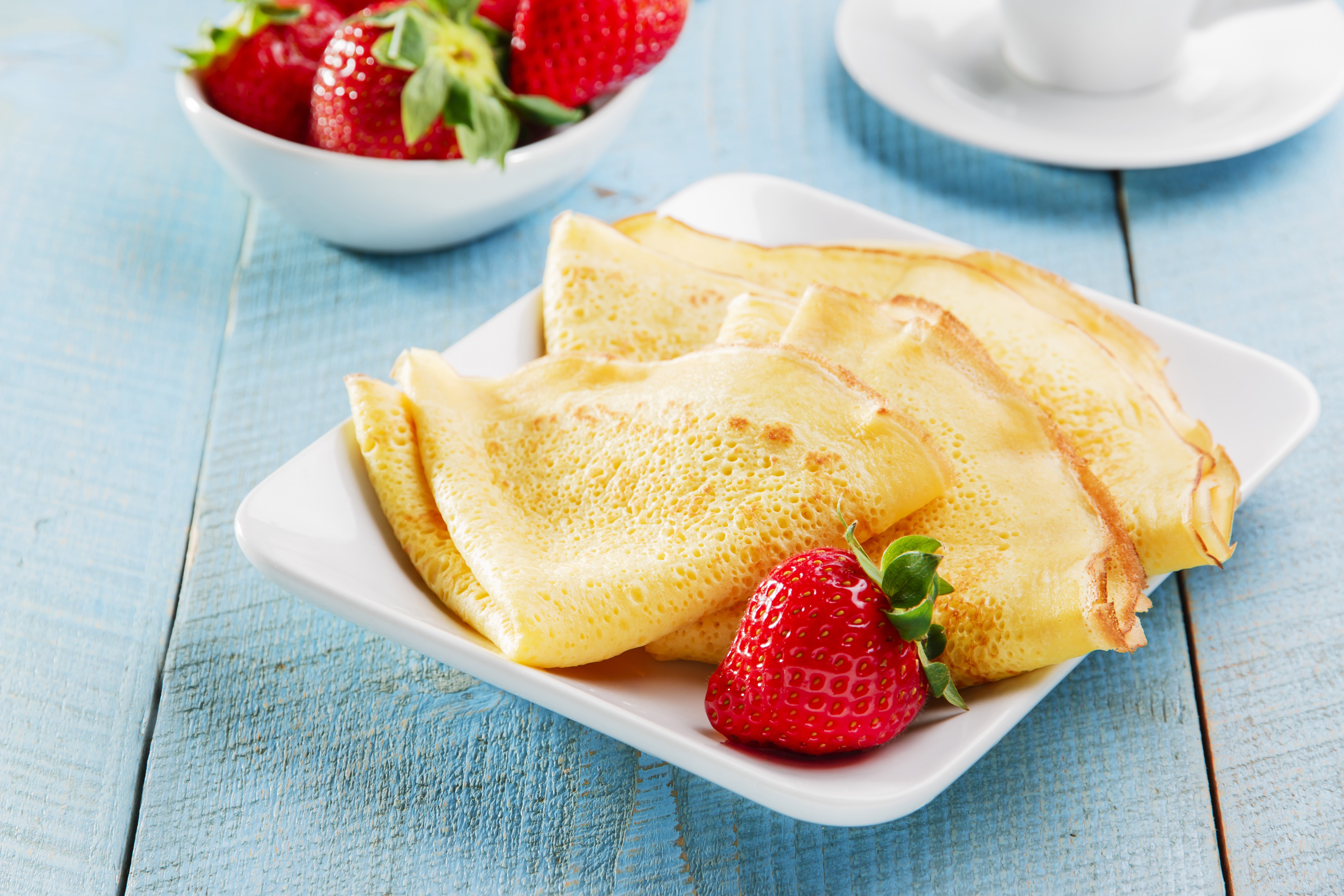 Pancakes with strawberries on a blue wooden table HD Wallpaper